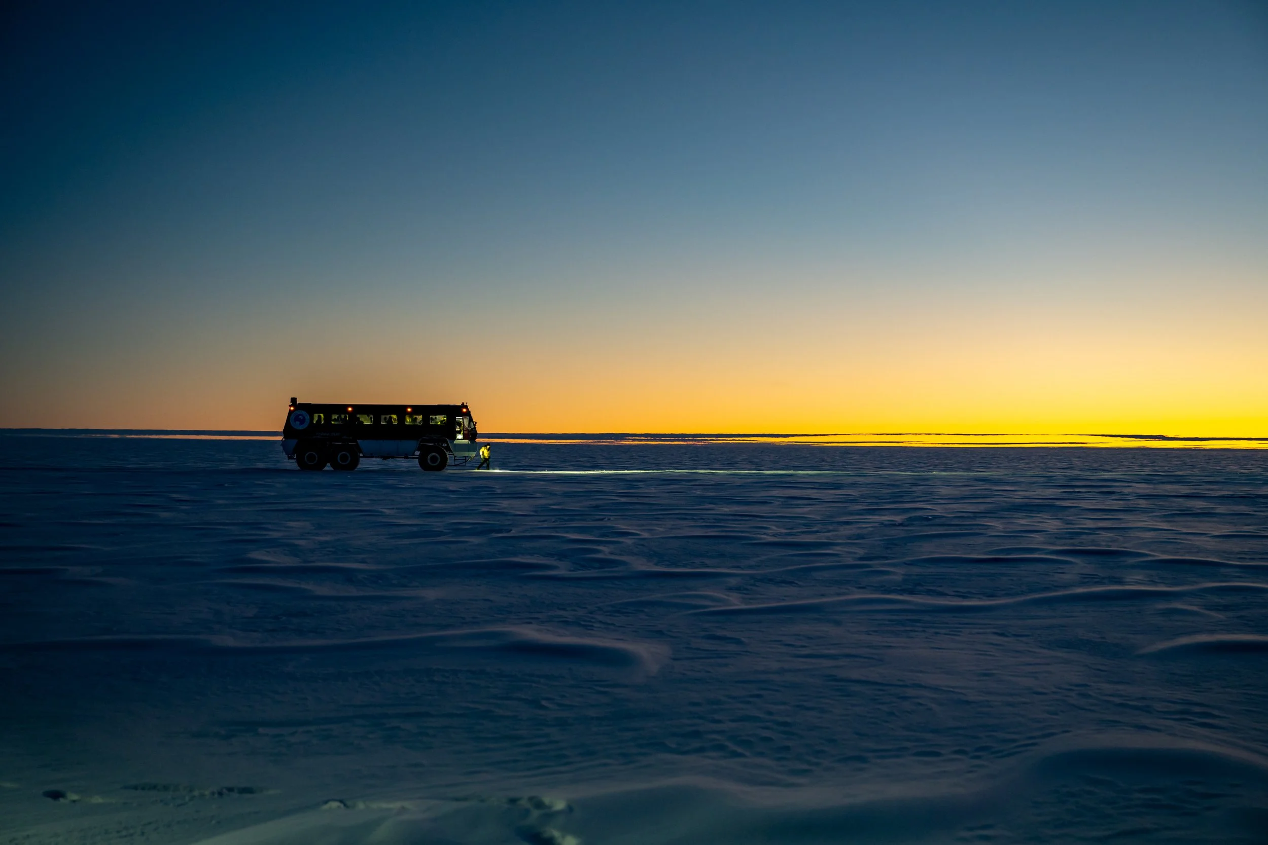 C156 - Heading across the Ice Plateau in the Terrabus to Wilkins Runway just before sunrise