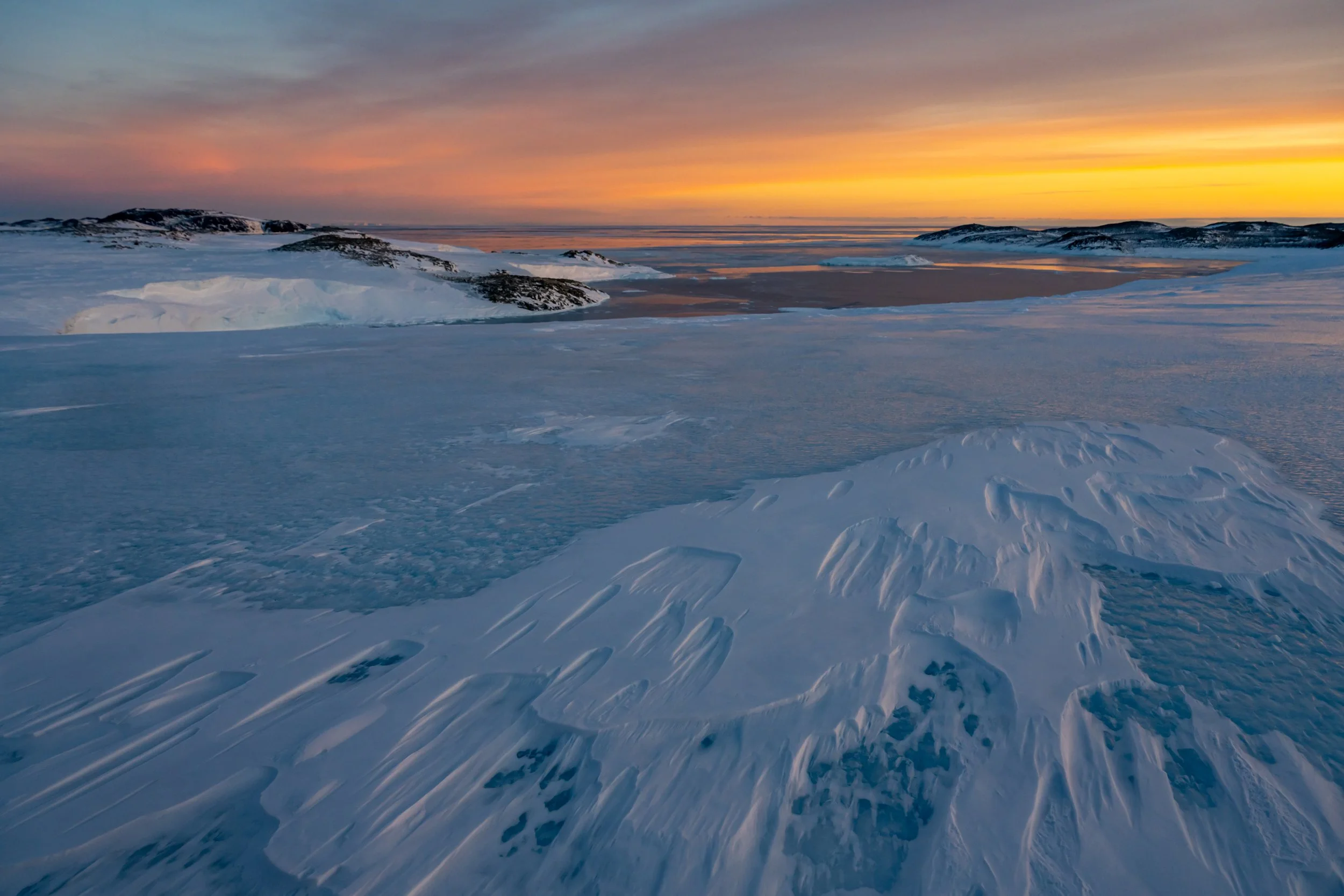 C261 - 29th of May 2022 2:31 pm - Mitchell Peninsula at sunset with beautiful wind sculptured ice in the foreground 