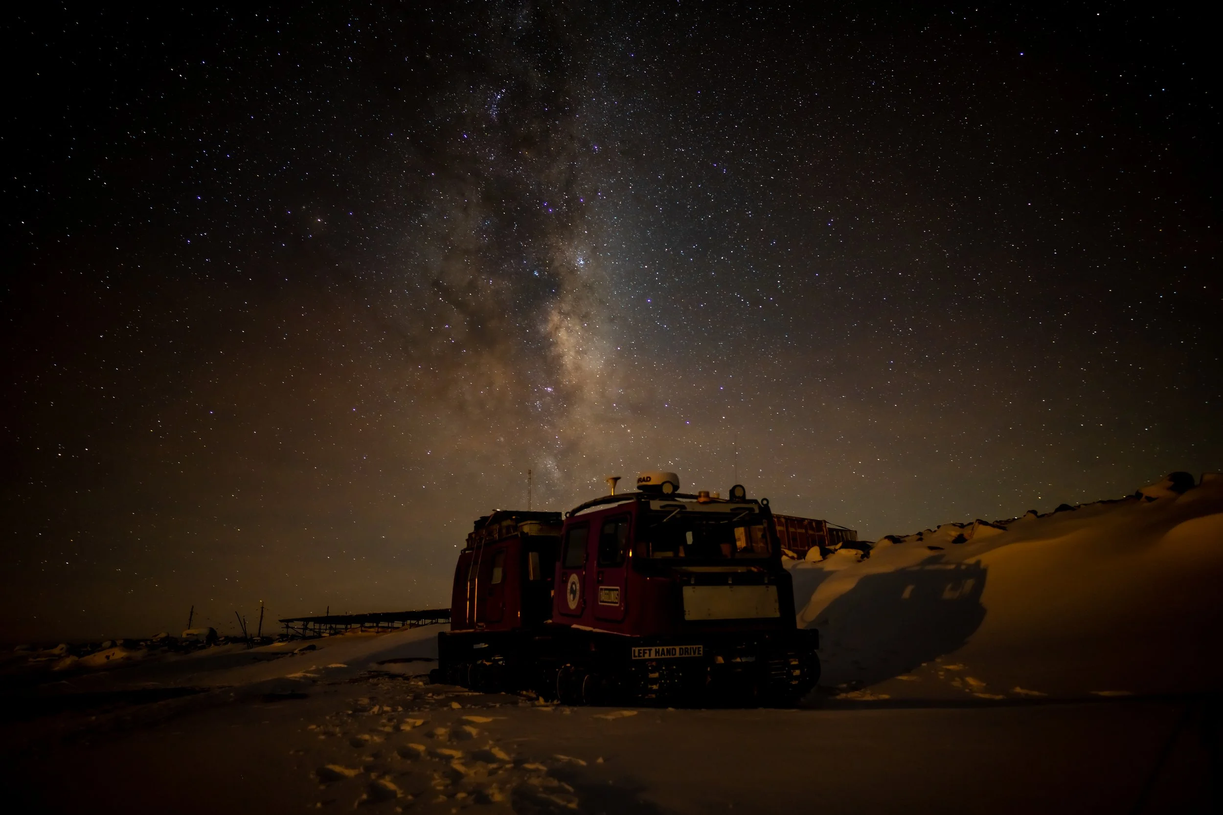 C292 - 9th of May 2022 9:23 pm - Purple Hägglund next to the fuel farm at Casey wharf with Milky Way in the background