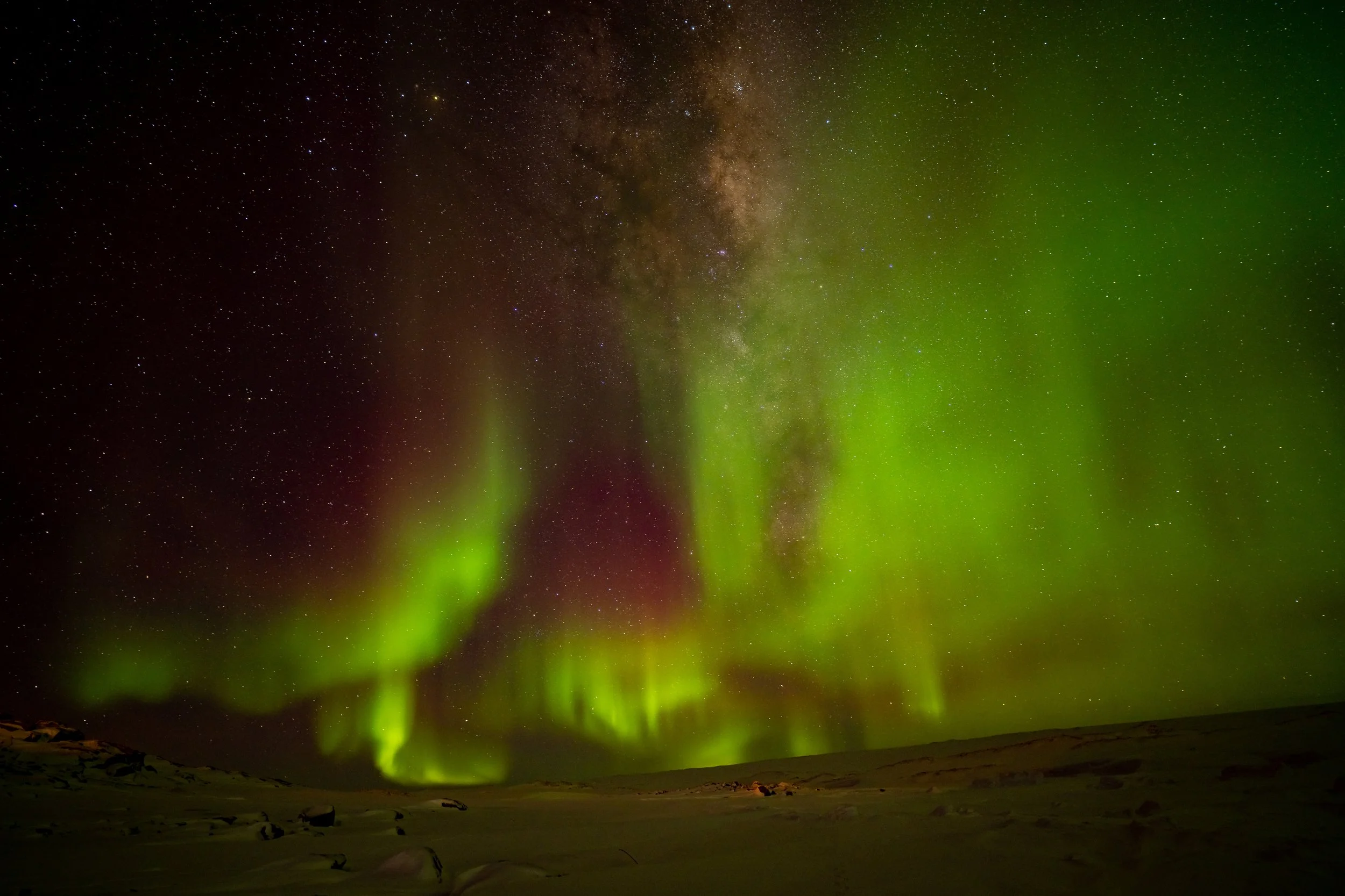 C319 - 25th of June 9:05 pm - Strong Aurora and Milky Way was taken whilst walking on the sea ice