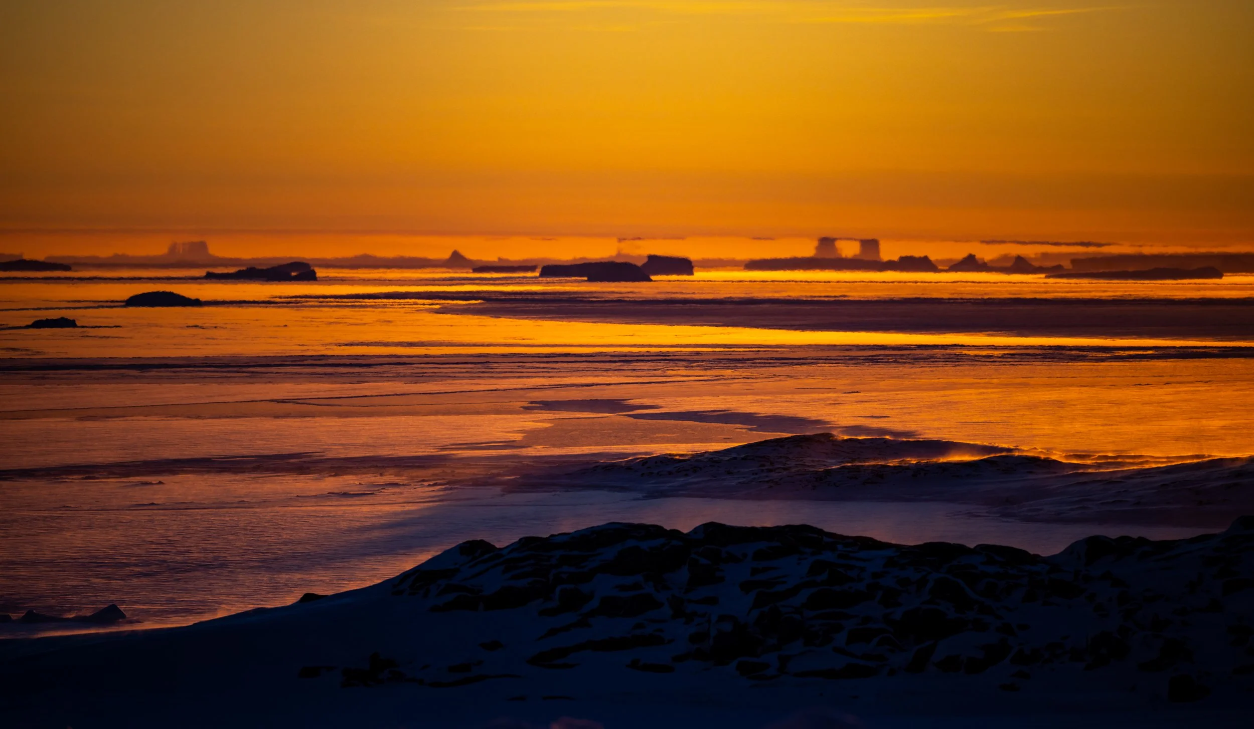 C334 - 13th of June 1:00 pm - awesome sunset over the icebergs with 'Fata Morgana' on the horizon in Newcomb Bay