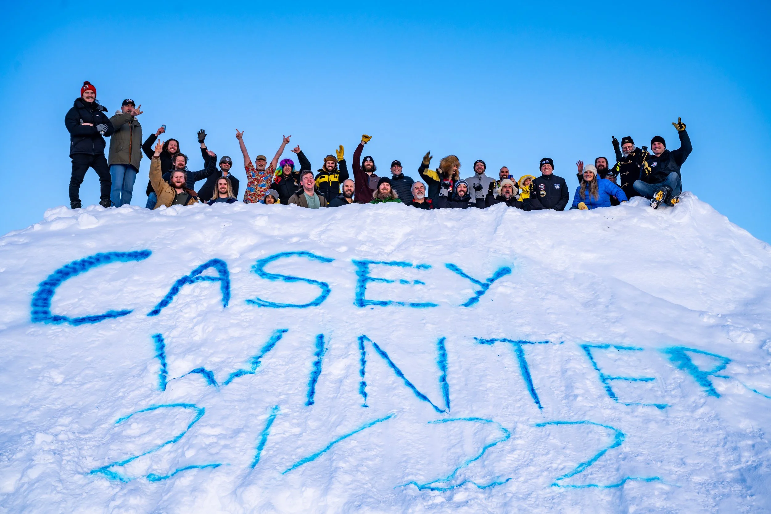 C346 - 21st June 1:40 pm - Casey Winter crew gather on the snow pyramid for a Mid Winter photo