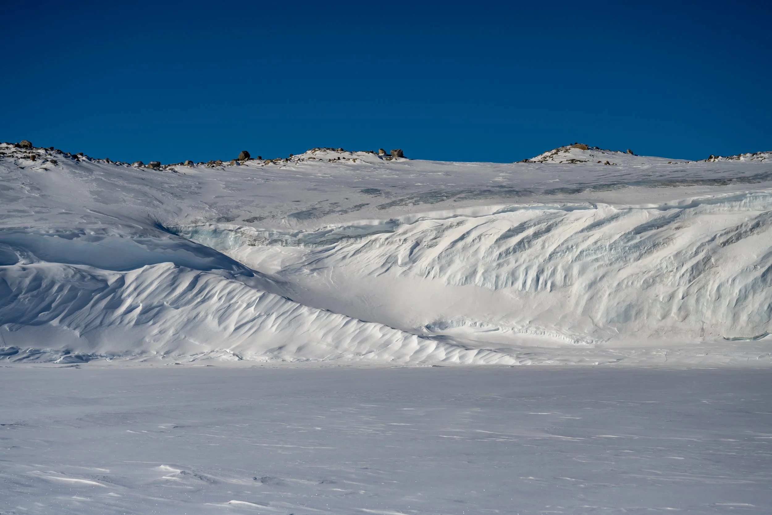C514 - 27th of September 11:52 am - Walking across the sea ice alongside the ice cliffs on the Mitchell Peninsula, heading to Casey Station