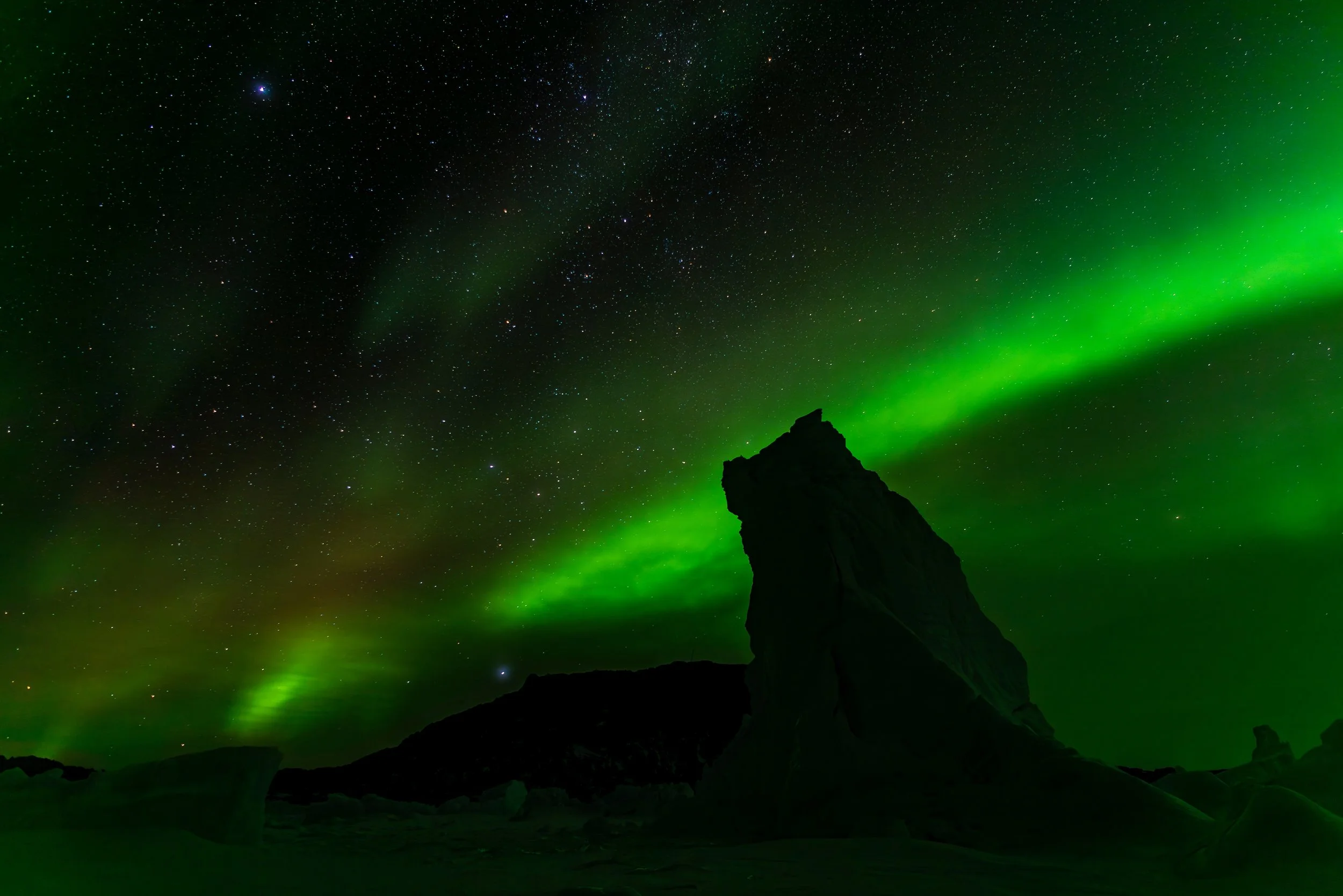 AA 074 - Davis Aurora 17th of June 2017 10:19 pm, iceberg silhouette near 'Bandits Hut'  - Nikon D750, 24mm, f/2.8, ISO 100, exp 15 sec