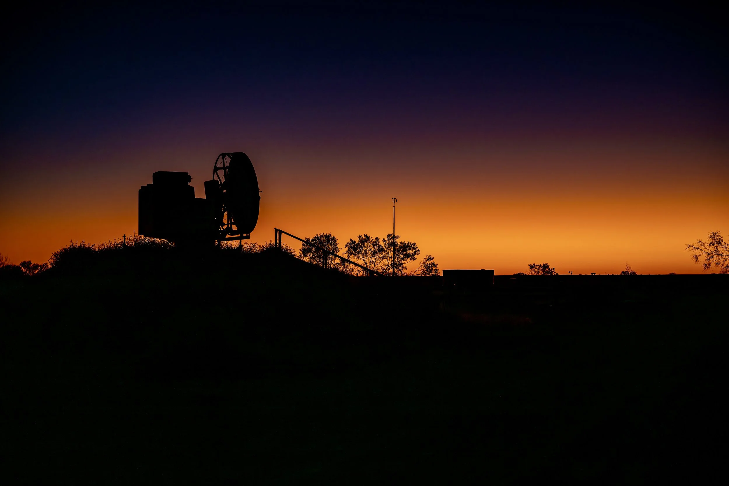G002- 27th of November 2024 19:24 - Silhouette of the 0ld WF2 radar and anemometer mast at Giles Weather Station. 