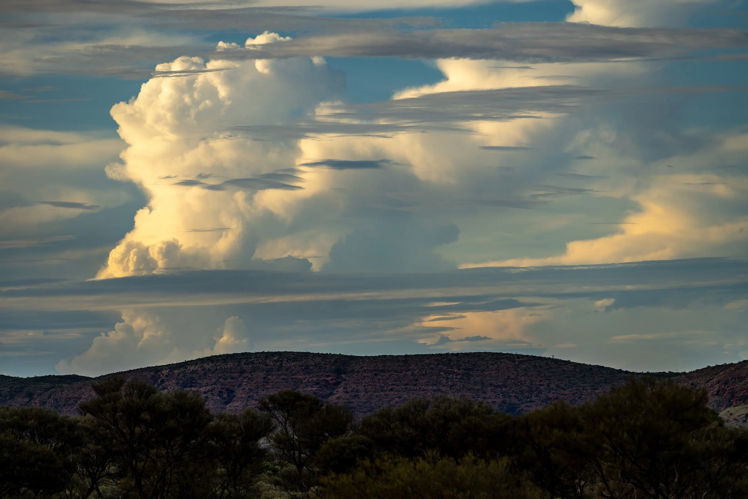 069- 8th of December 2024 17:58 - Late afternoon build up of cumulonimbus cloud - view from Giles to to the north of Purli Yurliya (Rawlinson Ranges) .
