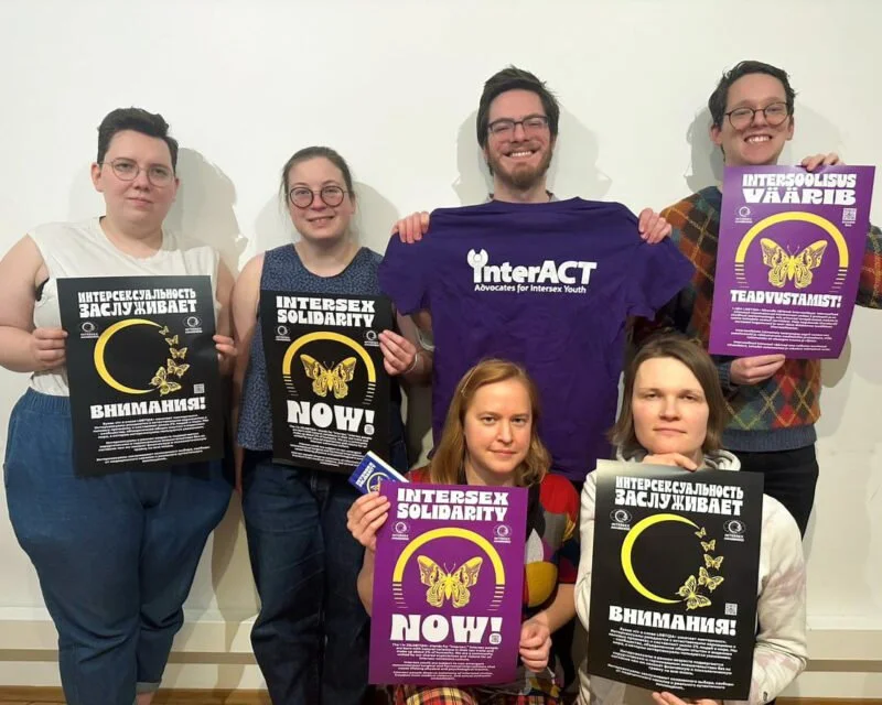 Group of intersex folks holding up supportive signs for interACT
