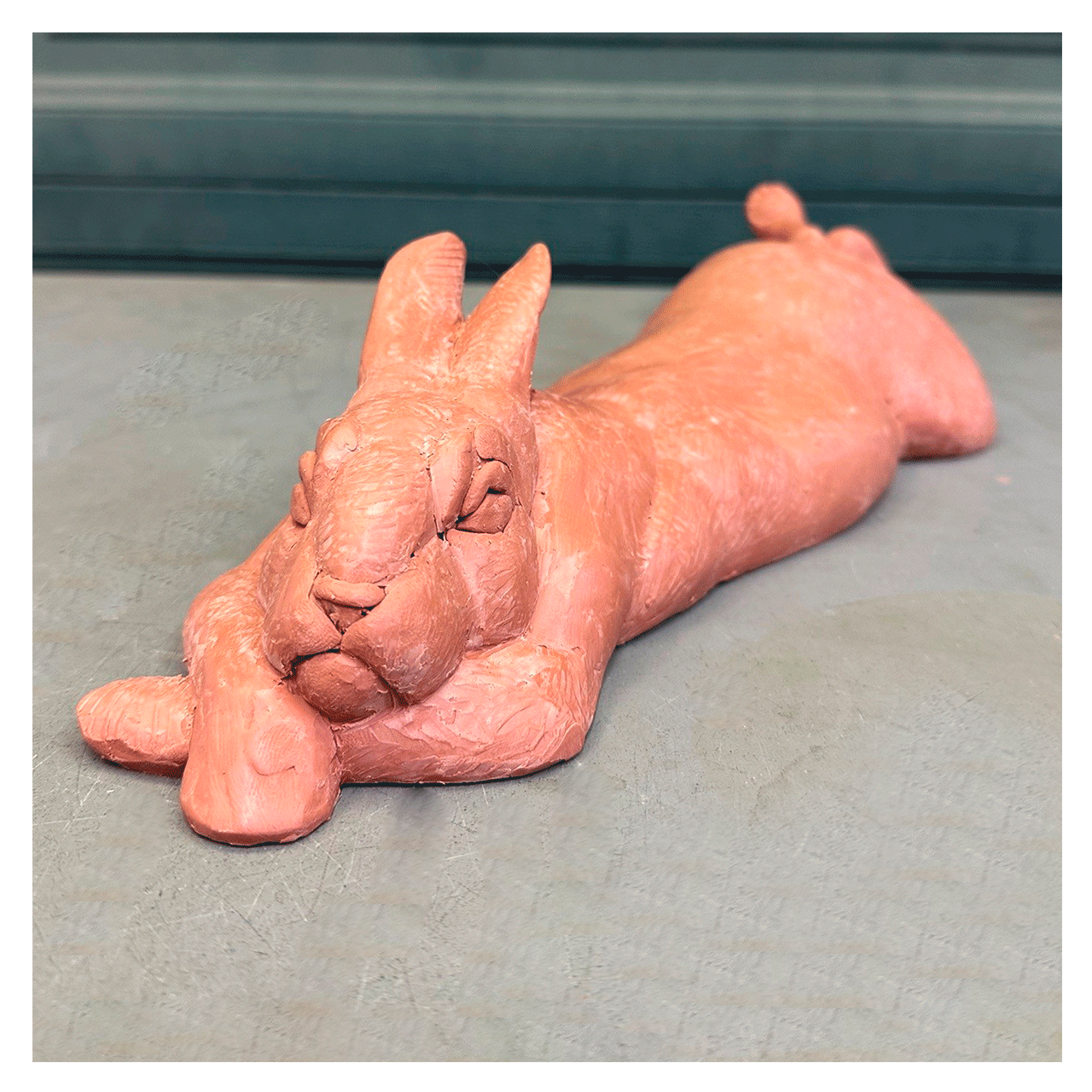 joshua-tobey-bronze-sculpture-rabbit-bunny-laying-on-belly-front-view.png