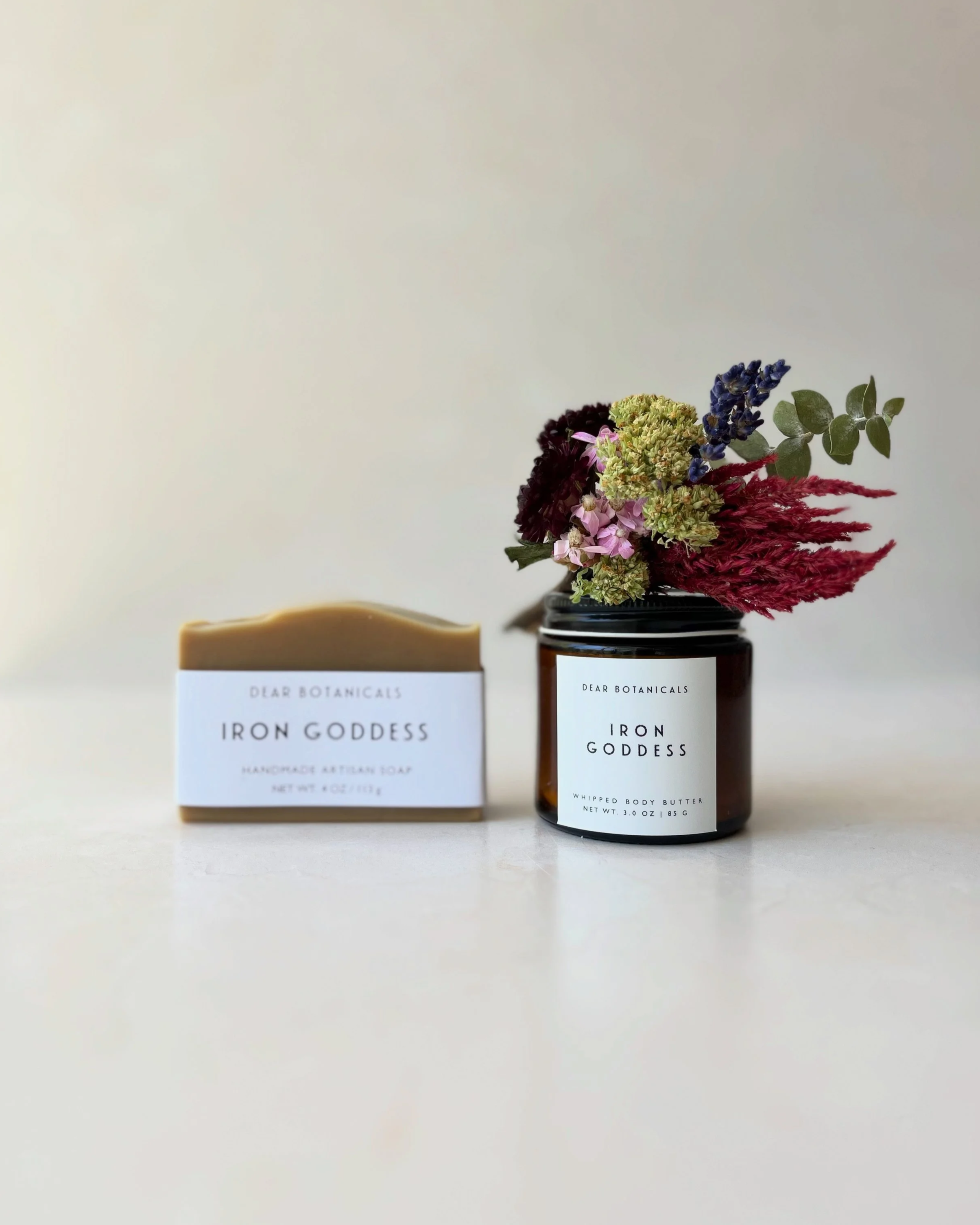 A bar of Iron Goddess soap with a jar of body butter