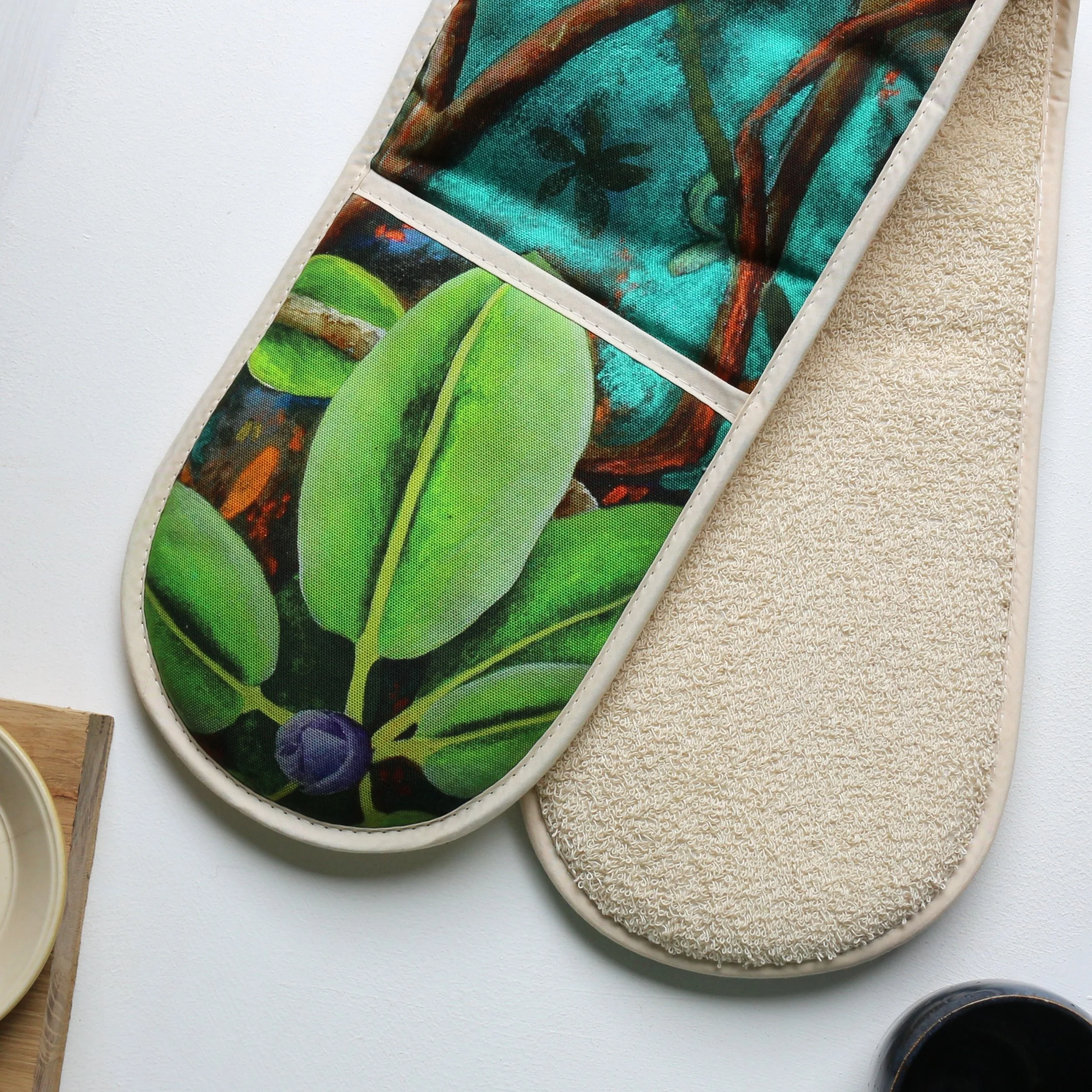 Double oven gloves with a vibrant print of an original painting of a rhododendron by mixed media artist, Katie Hammond