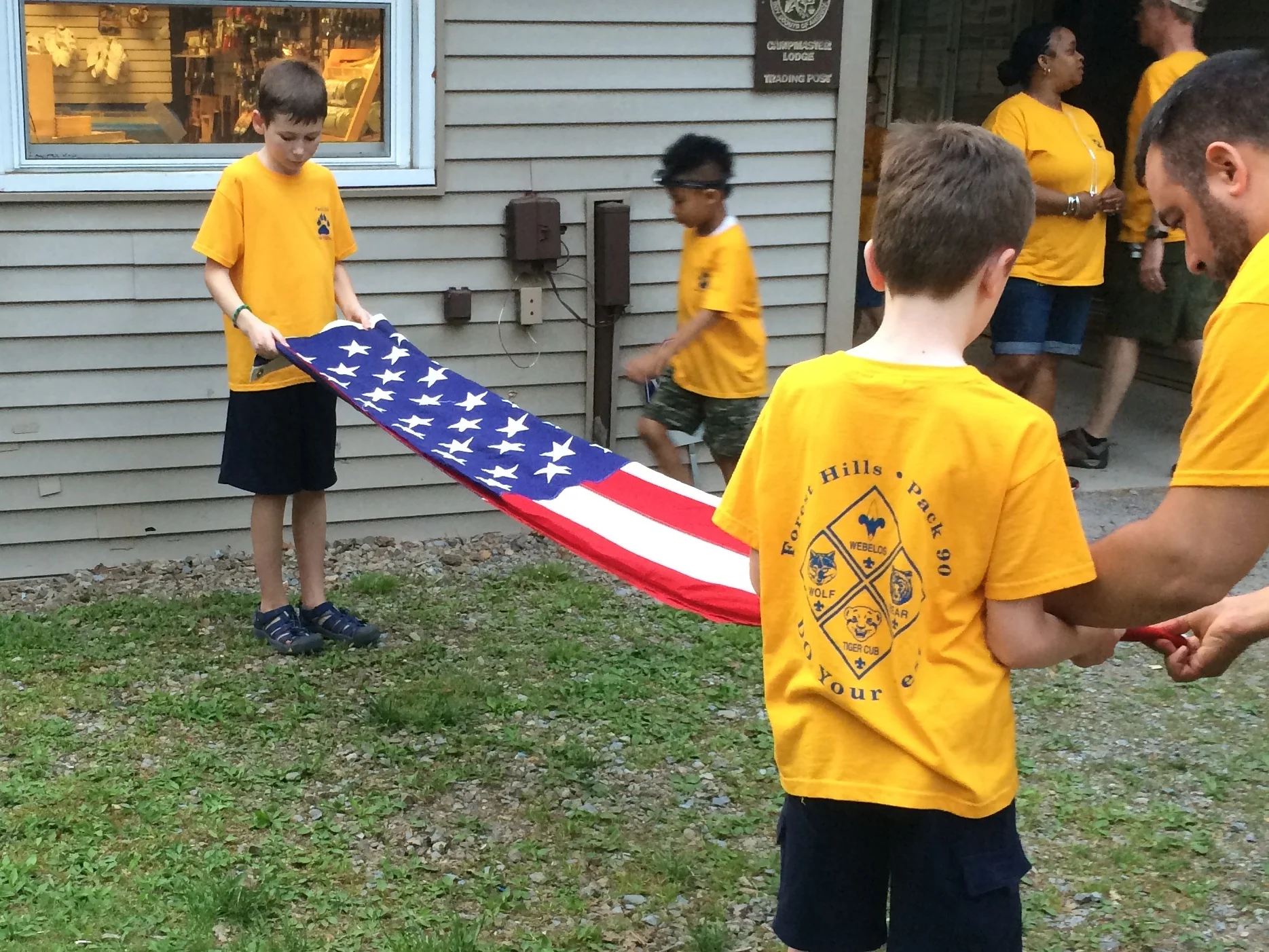 Pack 90 Webelos show reverence during a flag ceremony at Summer Camp.