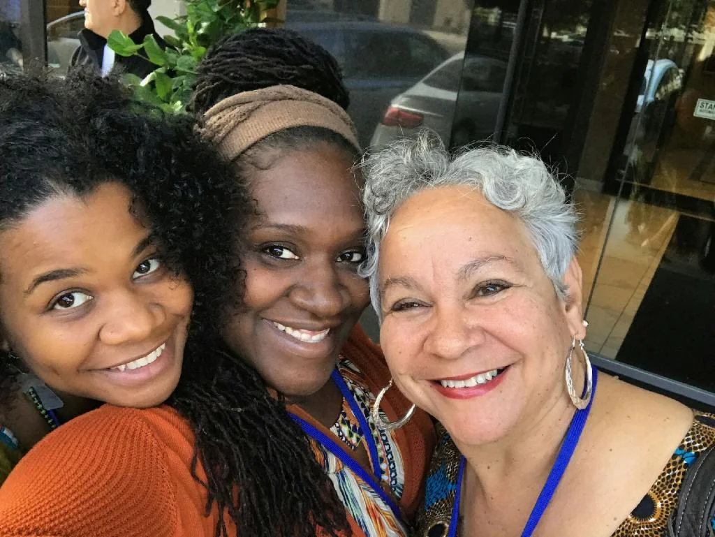 Tashiya Umoja (left), Nkenge Ayo Nkita-Mayala (center), Aminata Umoja (right)