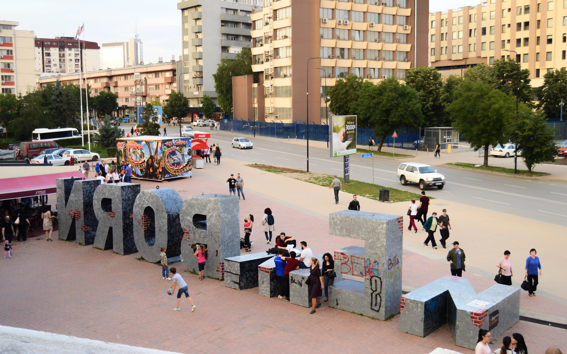 Children climb on the Newborn monument outside of the Youth and Sports Center in Pristina.