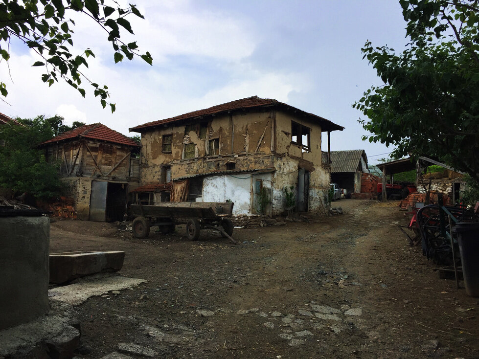 A farmhouse in the ethnically-mixed village of Susica sits near open-sewage.