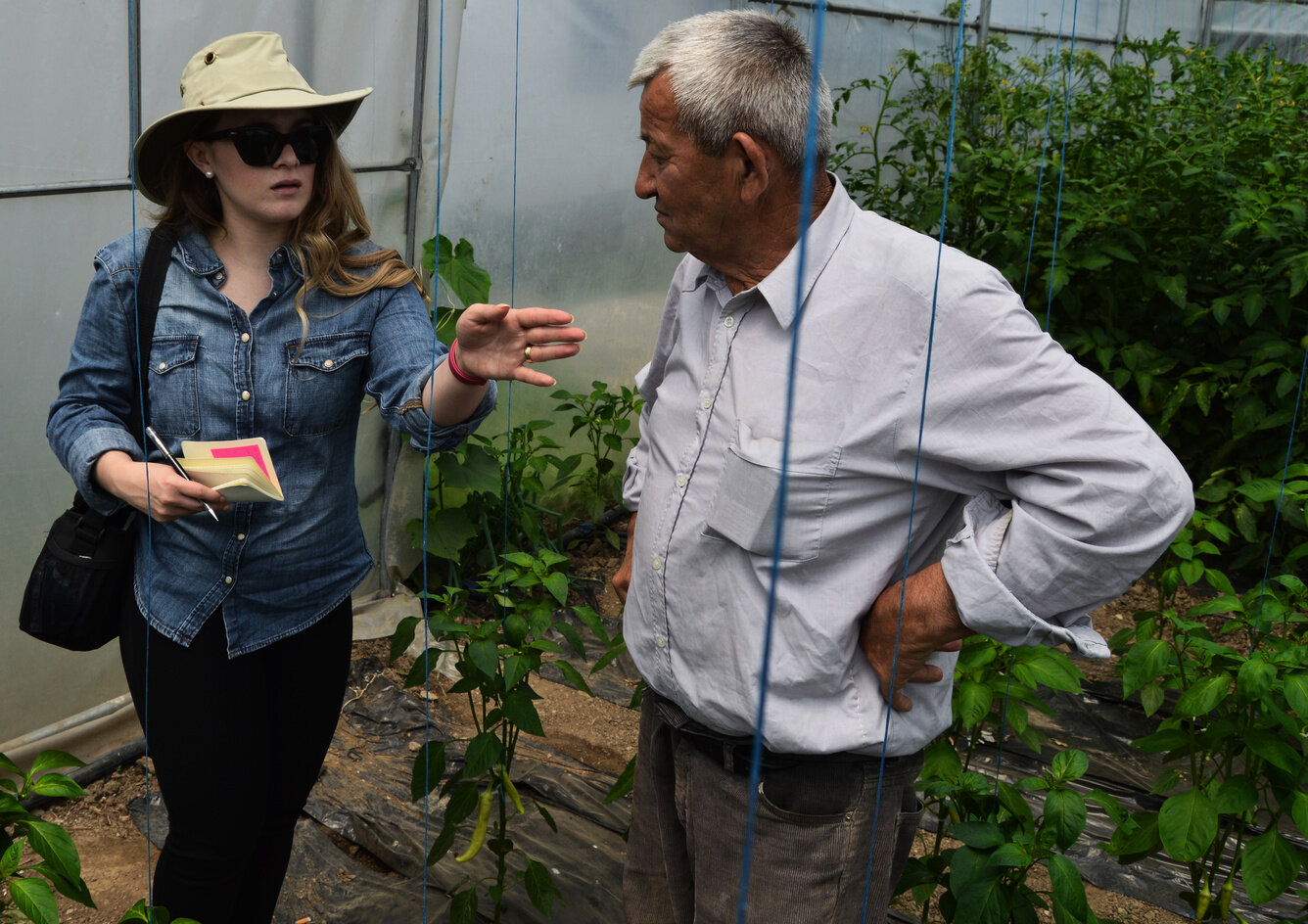 The photographer interviews a Kosovar Serb farmer in his greenhouse in Klokot, a Serbian enclave.