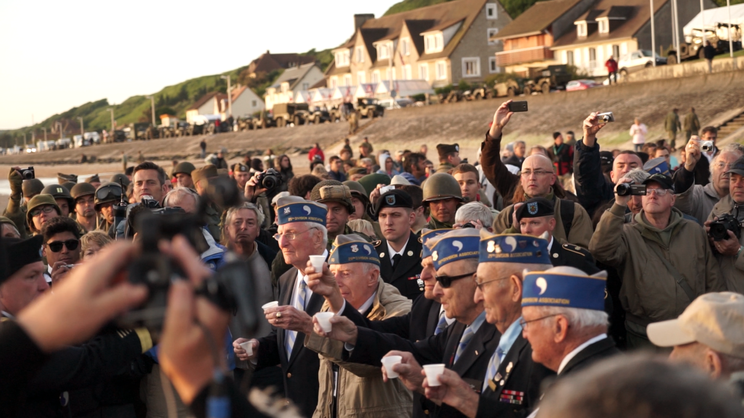 Veterans of the 29th division raise a toast to their fallen comrades at the Omaha Beach ceremony. 