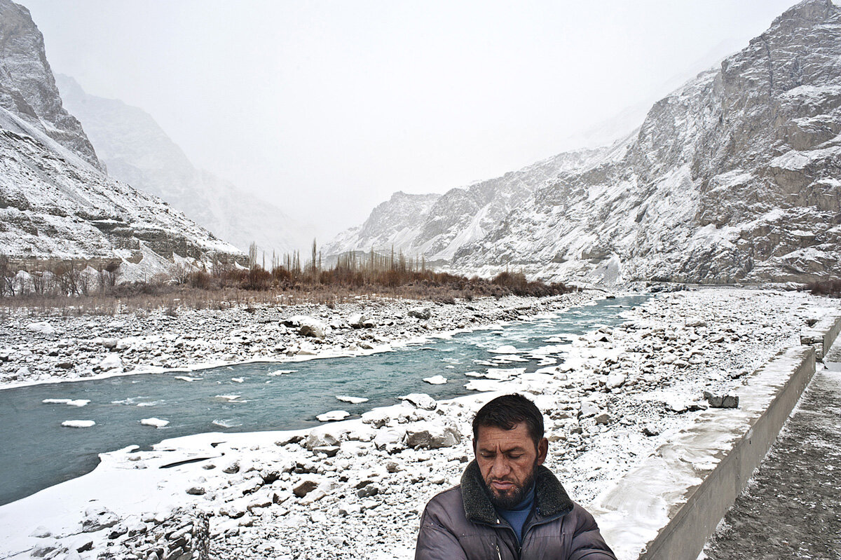  A man perches on an old wall looking over the Shyok valley where the Shyok River enters into Pakistani Baltistan after passing Tyakshi village. 