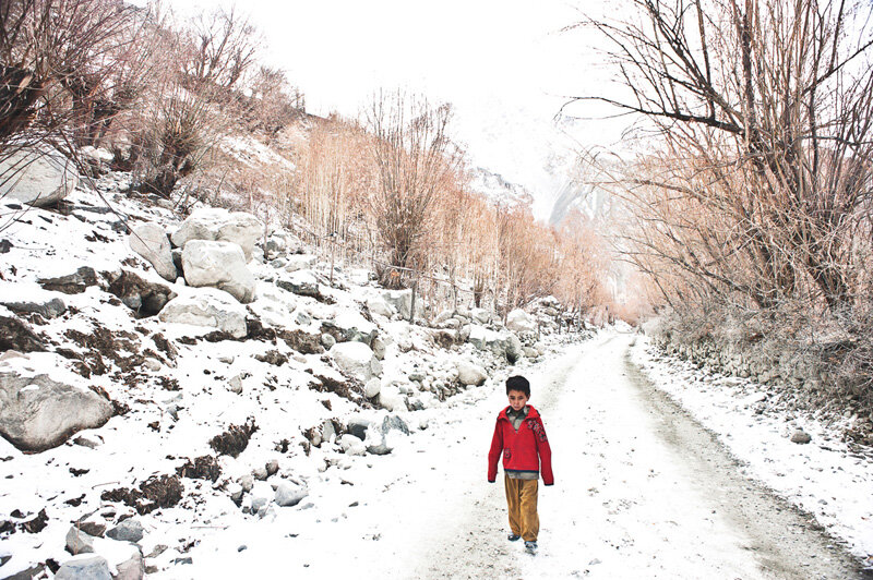 A Balti boy wandering on National Highway 1D on a snowy day.  