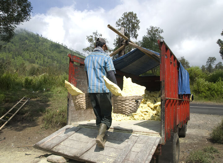  A miner loads his haul onto the truck to be carried down to a nearby sulfur factory. 