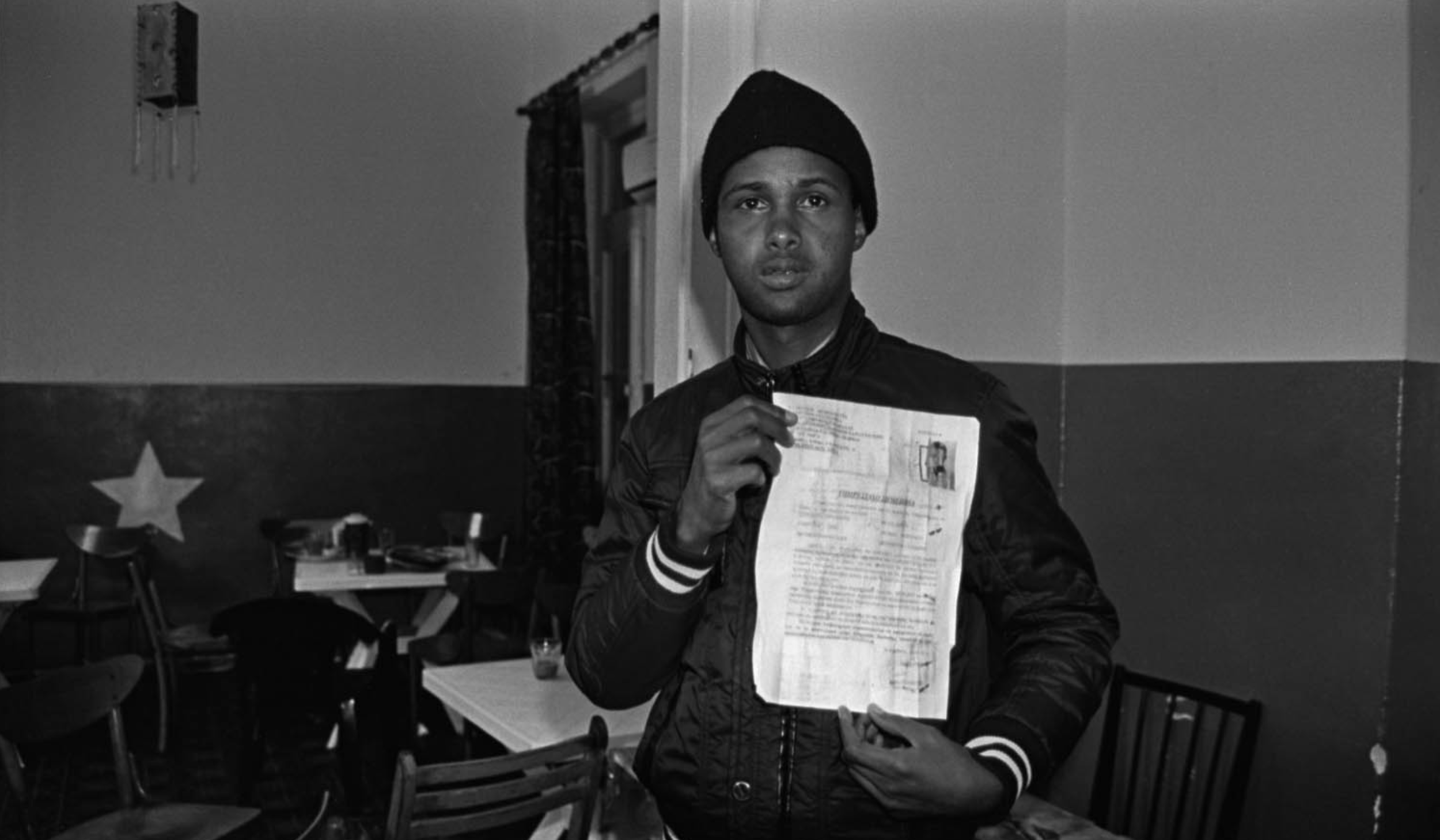  A Somali migrant in Athens, Greece, displaying the 30-day permit given to all migrants released from Greek detention centres. The reality for most such immigrants, who have spent all their resources in getting to Greece in the first place, is that t