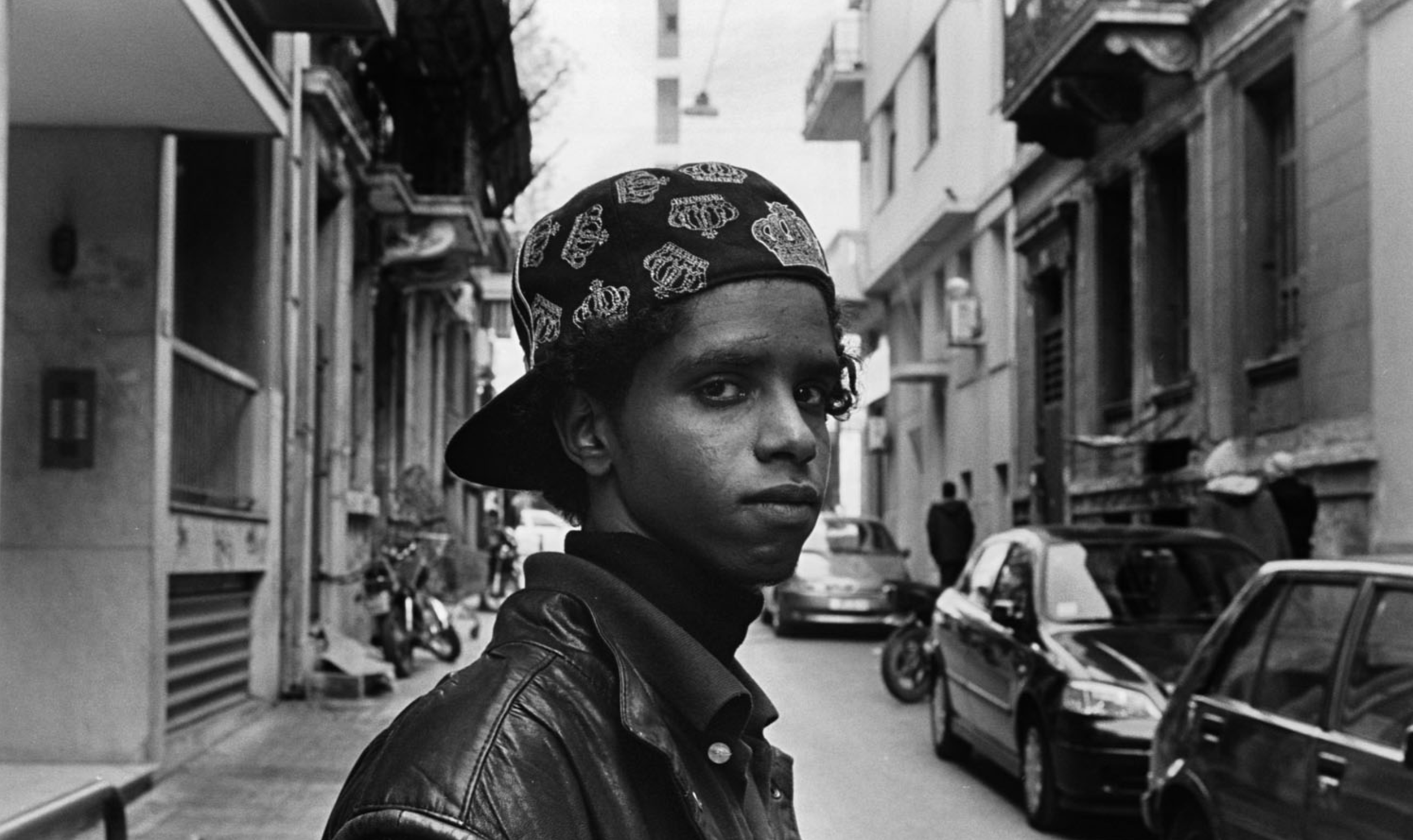 Somali migrant boy in a street in western Athens.  This boy introduced himself to me with a plea to help him get to school or find a job. He lives in a cramped two room-apartment with four female and ten male immigrants. 