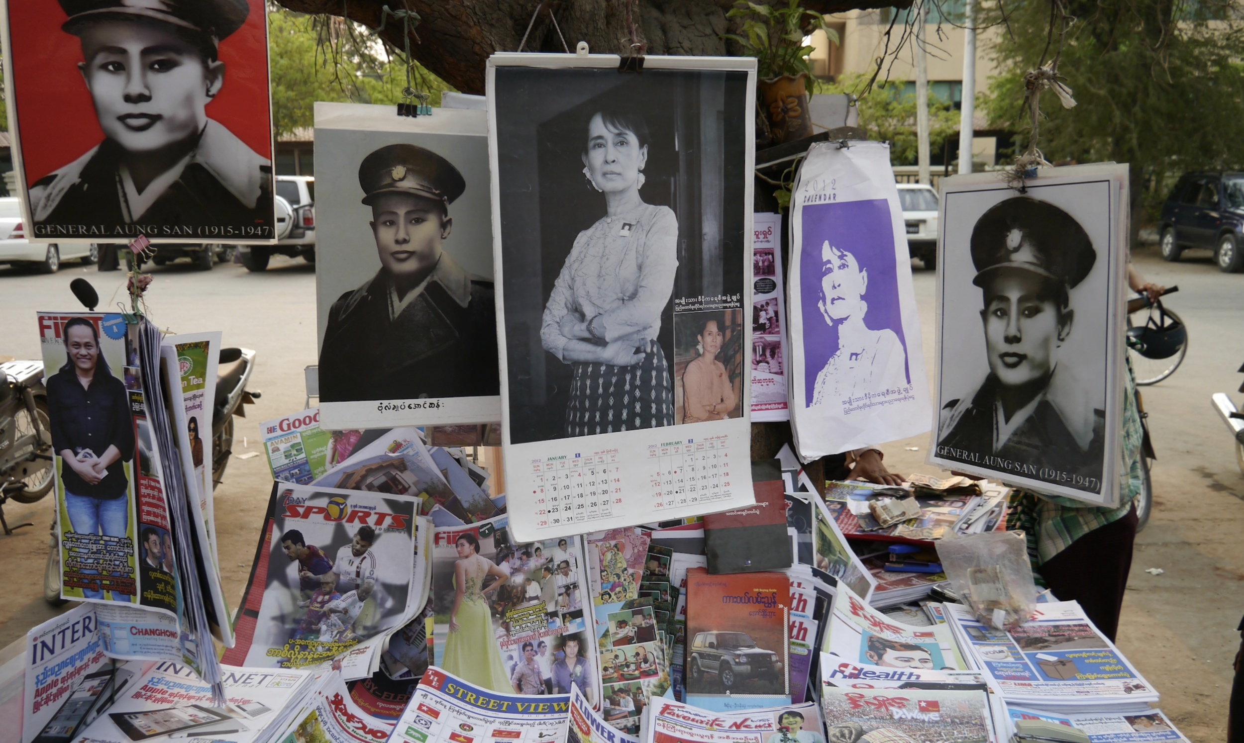  In marked contrast to the time when Suu Kyi’s image was effectively banned, today streets across Burma – like this one in the former royal capital of Mandalay – are festooned with posters and graphics of Suu Kyi and her father, General Aung San, who