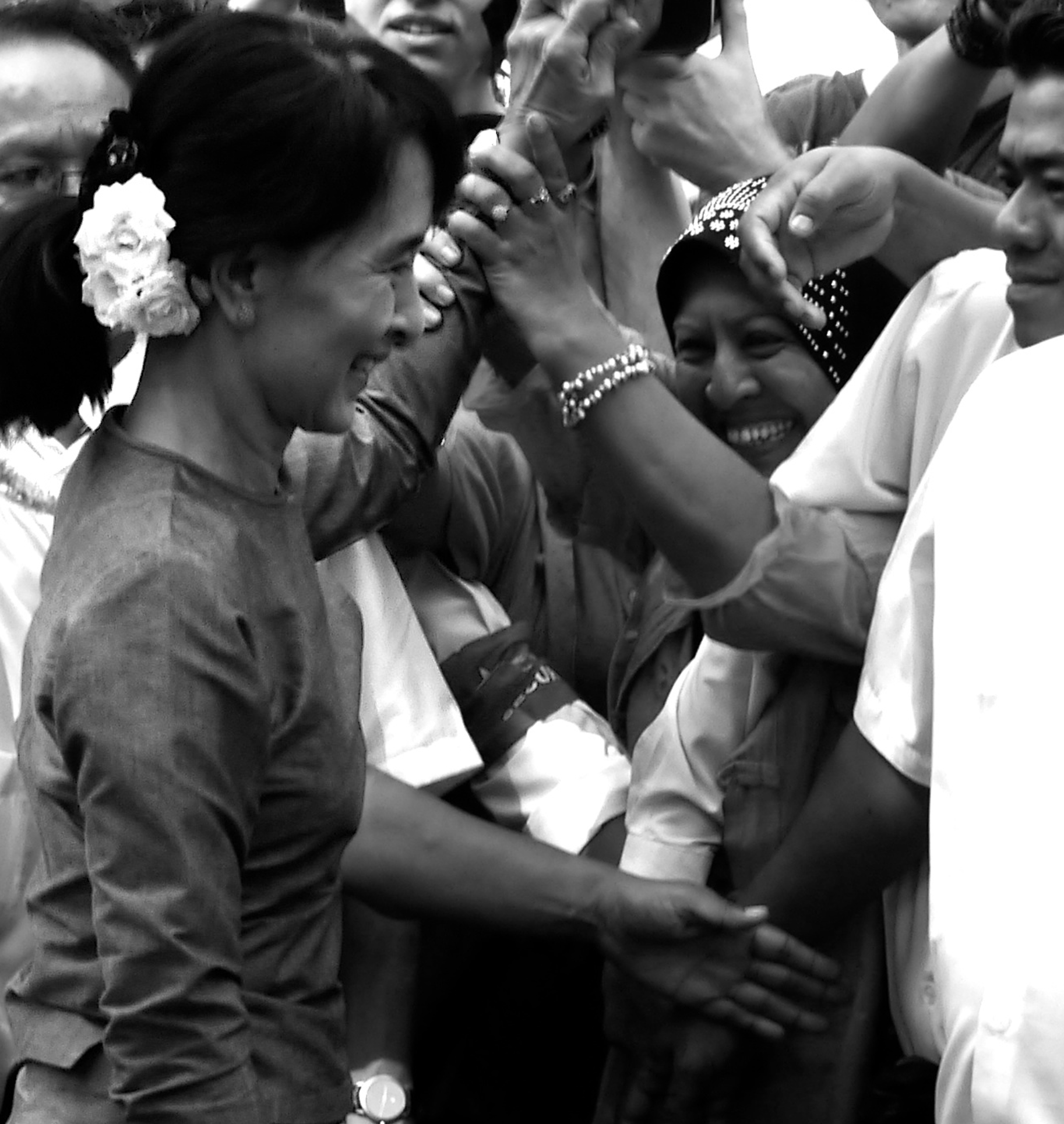  Suu Kyi greeted by supporters after news of her victory. 