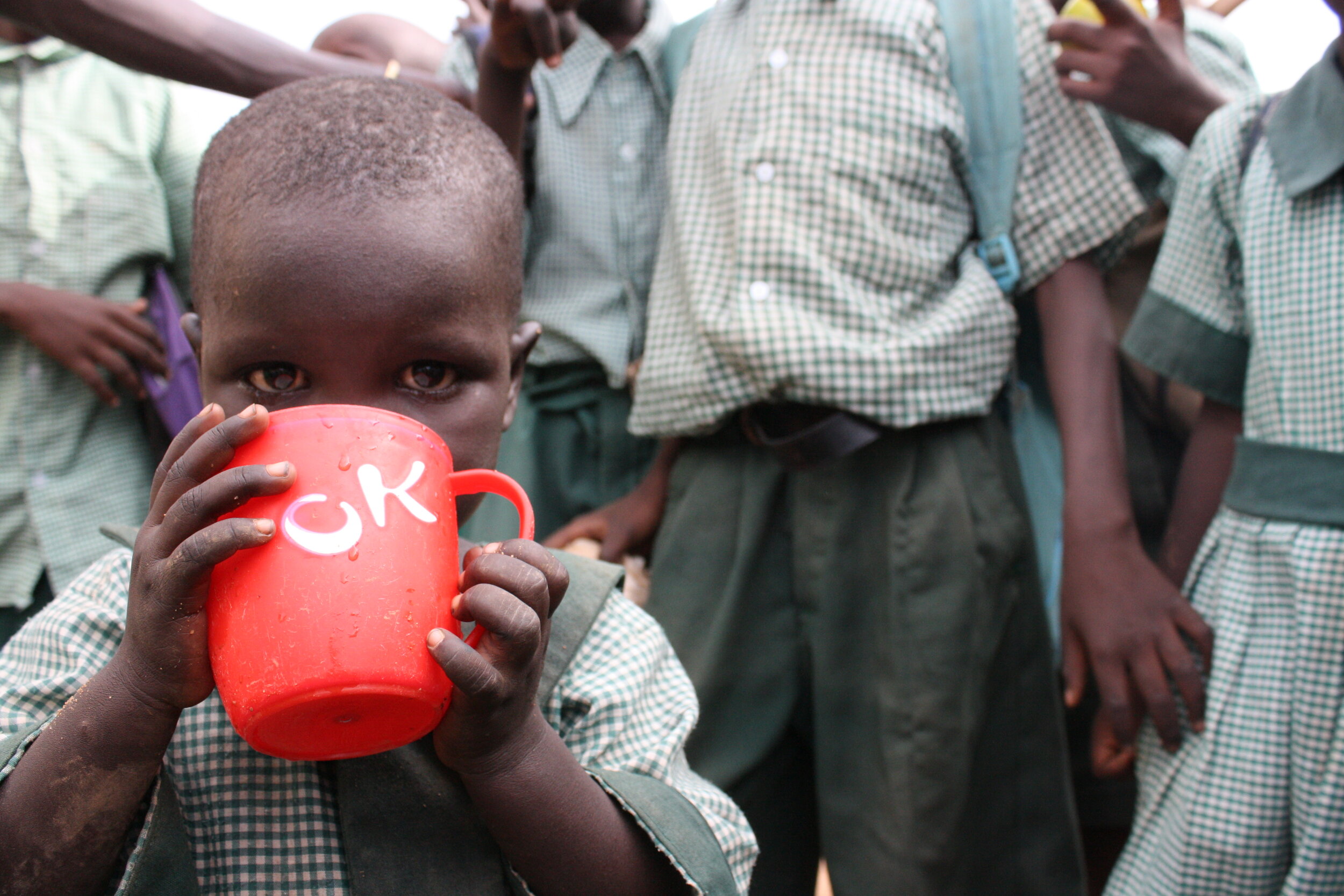 A student takes a drink of water near the end of the school day in Kakuma. 