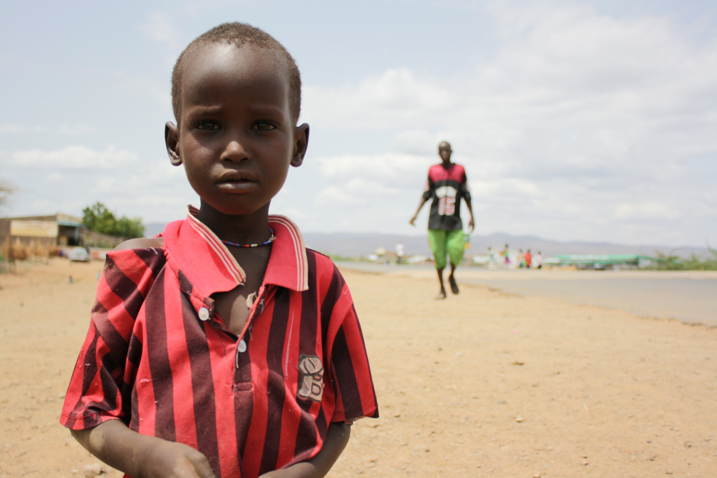  In Kakuma Town, a young boy takes a break from searching for friends to play with. 