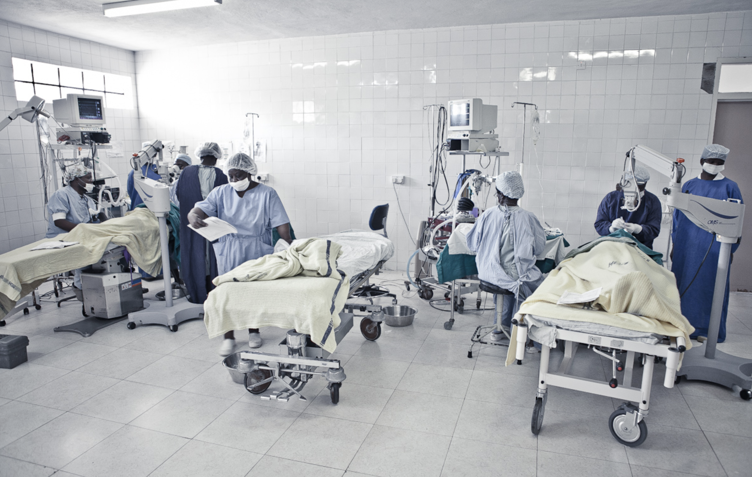  Two surgeons operate at the same time in the main theatre at the Lions Sight First Eye Hospital 