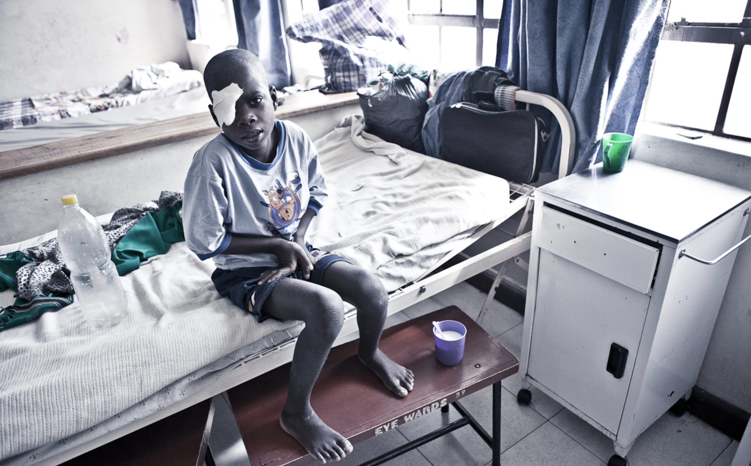  Child cataract patient sitting on his bed in the children's ward of the Lions Sight First Eye Hospital in Blantyre 