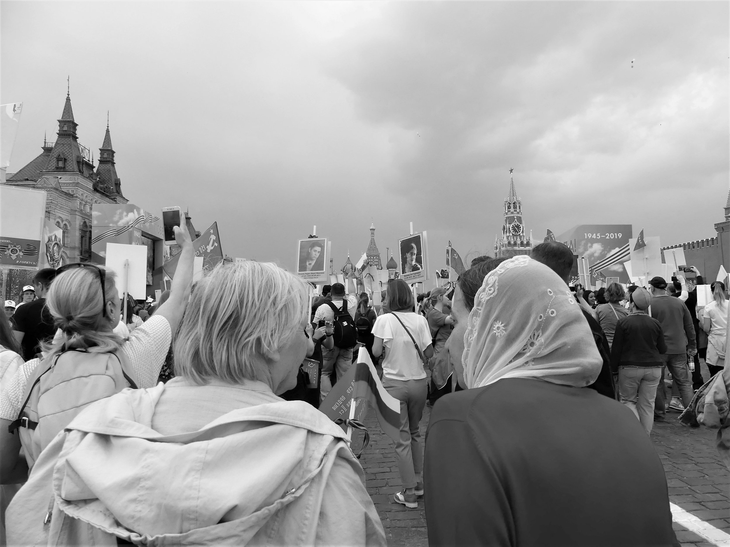  Two women quietly share their thoughts in the noisy crowd. 