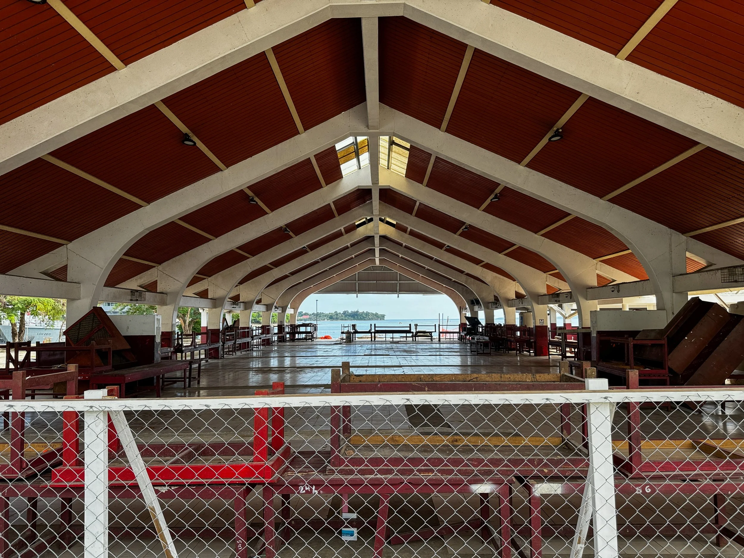   Photo 6 : The Port Vila Market sits empty, its iconic high-pitched A-frame roof still structurally unsound following the December 2024 earthquake. 