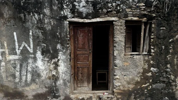   Photo 6:  The weathered entrance of a home. In the borderlands, such worn thresholds represent the thin line between the memory of a lost past and the enduring struggle to build a new life in exile. 