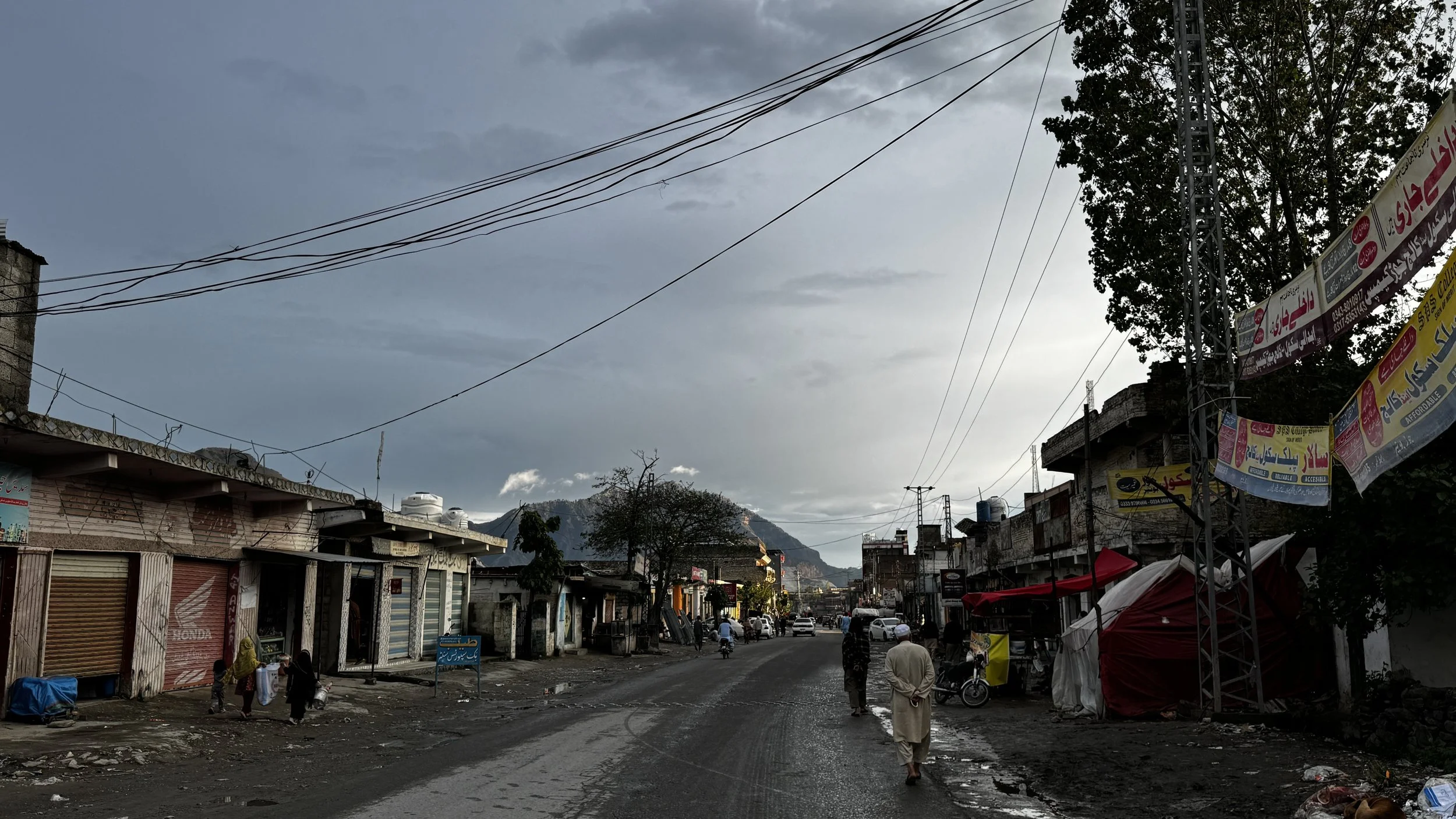   Photo 2:  A street in a displacement settlement in Khyber Pakhtunkhwa, Pakistan. For many Afghan refugees, these urban peripheries are the only places where they can find informal work, often in high-risk sectors like mining and construction. 