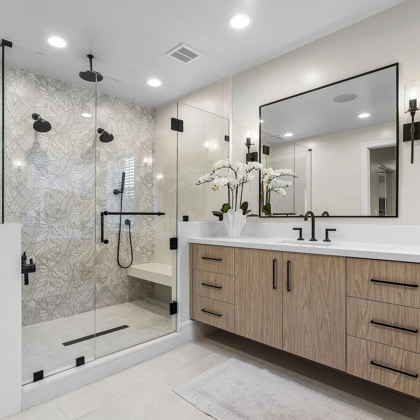 Swipe to see this spa-inspired master bath transformation ✨ We demolished the very dated cherry wood cabinetry, corner tub, and closed-off layout &mdash; and brought in calming, modern vibes.

Now featuring:
Neutral palm leaf pattern porcelain wall t