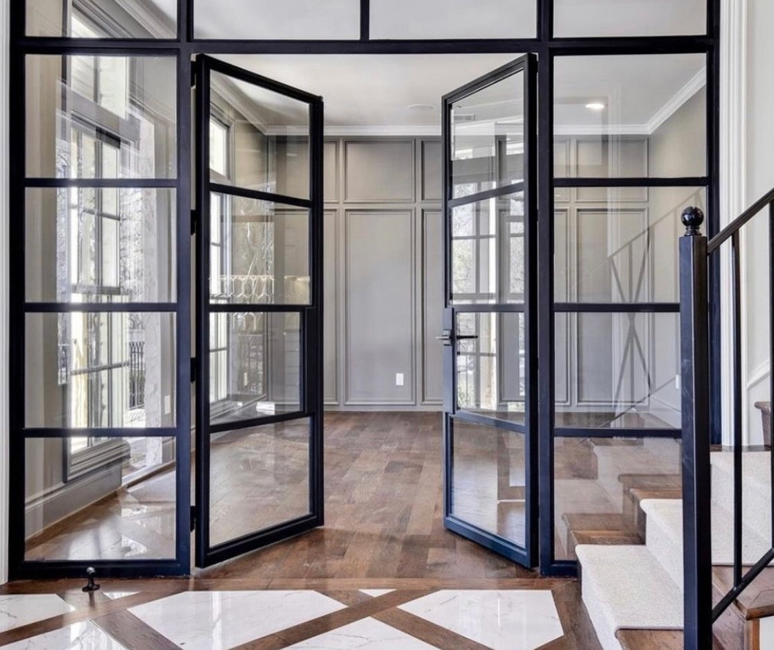 Matte black&ndash;framed glass doors into your home office ~ far more elevated than standard doors &amp; a simple design element that jazzes up the entry and makes the space feel intentional and special. 

#elitelivingbuilders