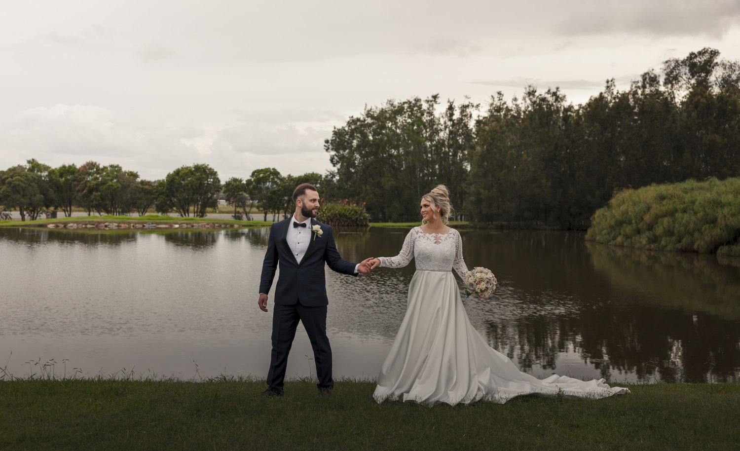 Newly married couple photographed beside the water in the Hunter Valley