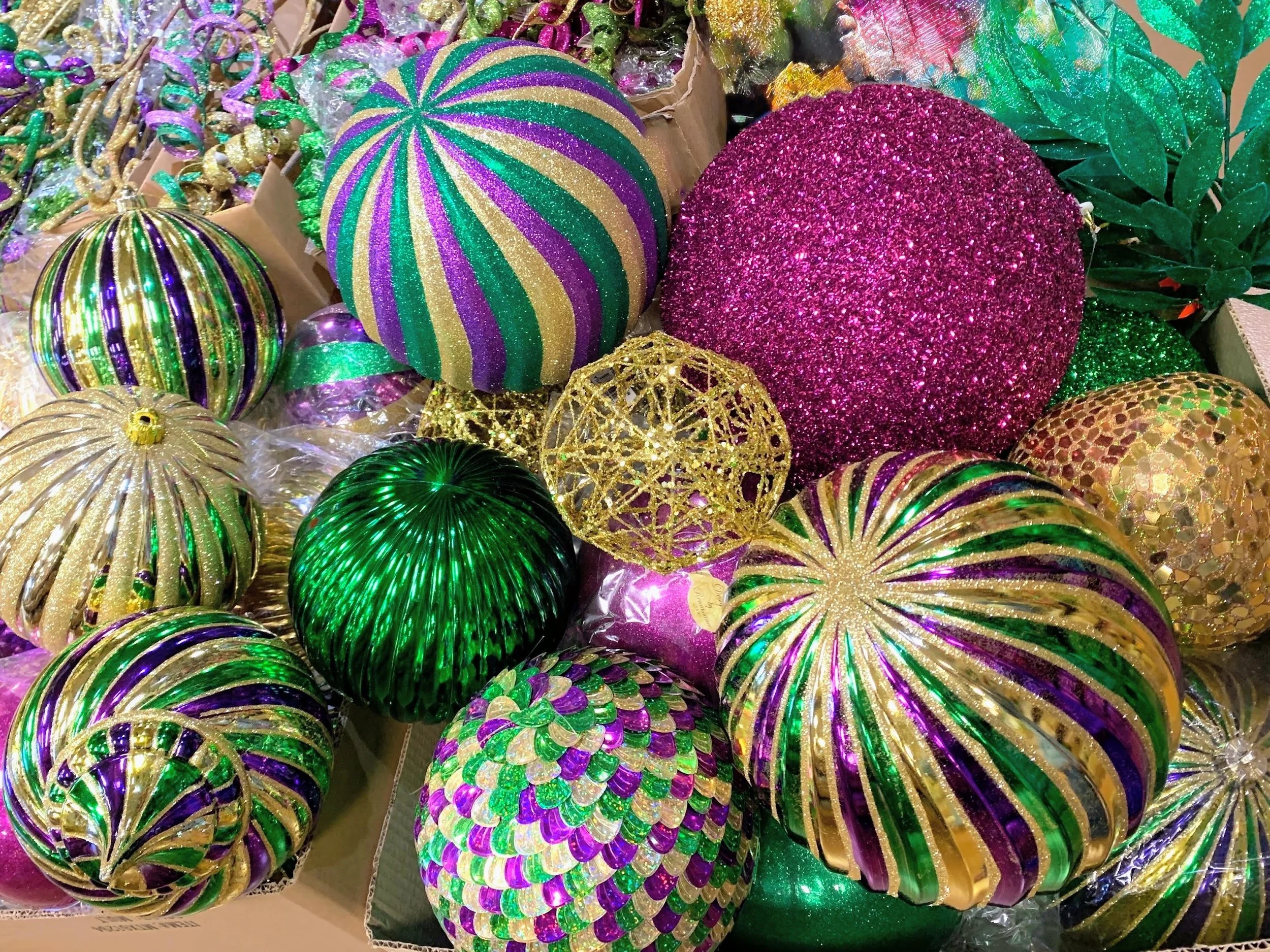 Mardi Gras ornaments and balls in assorted glitter, striped, and glass-look finishes