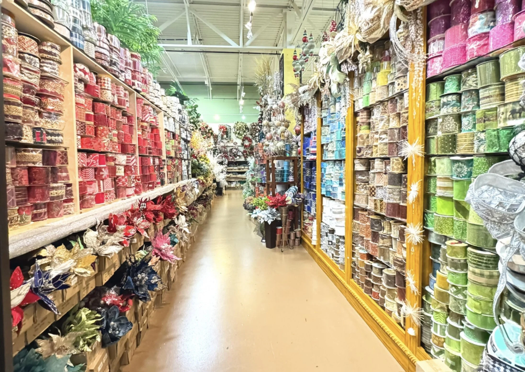 Decorative ribbon in Houston with hundreds of rolls in seasonal colors and patterns lining the Arcadia showroom aisle