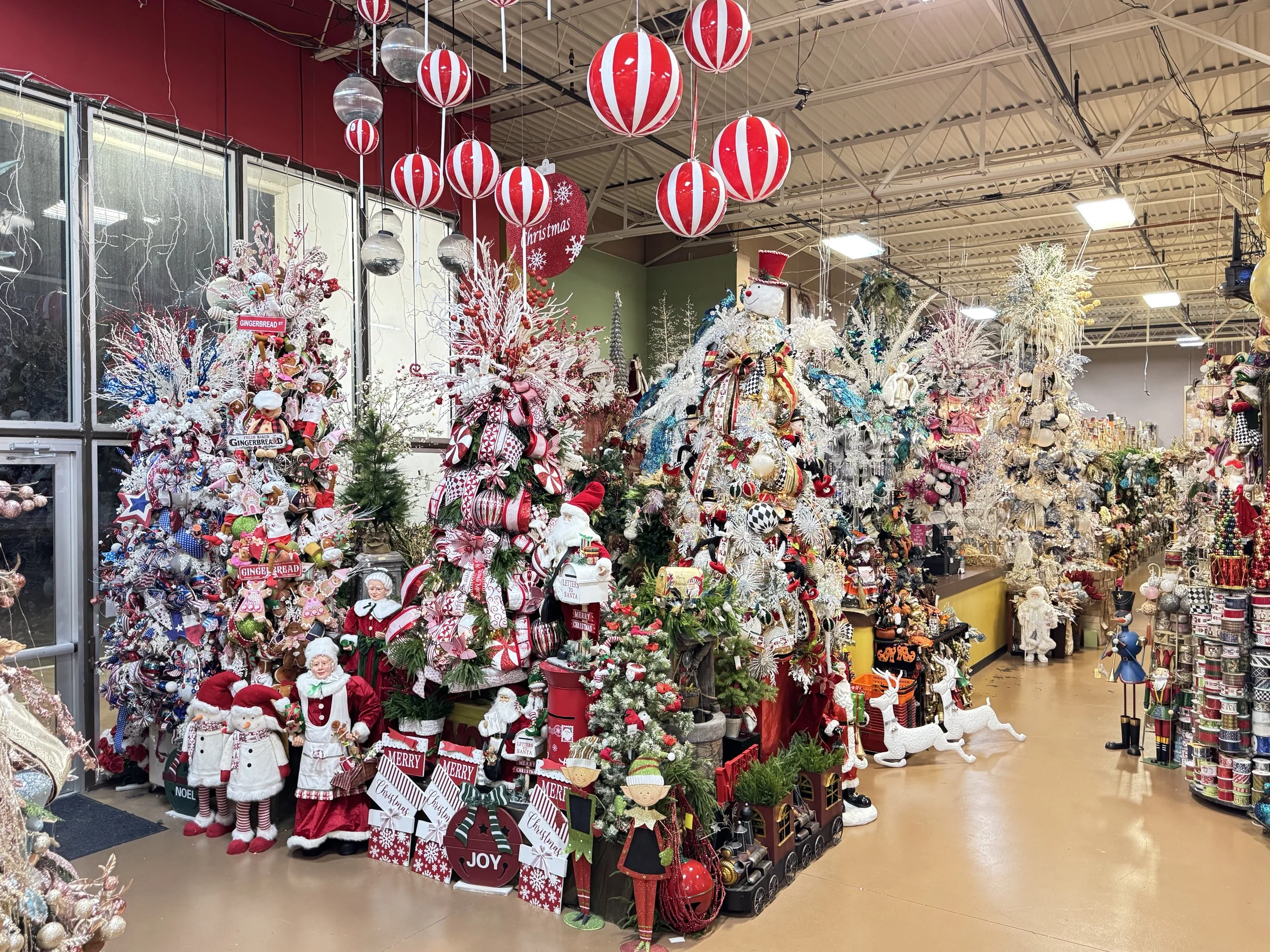 Rows of themed designer Christmas trees on display at Arcadia's Houston showroom