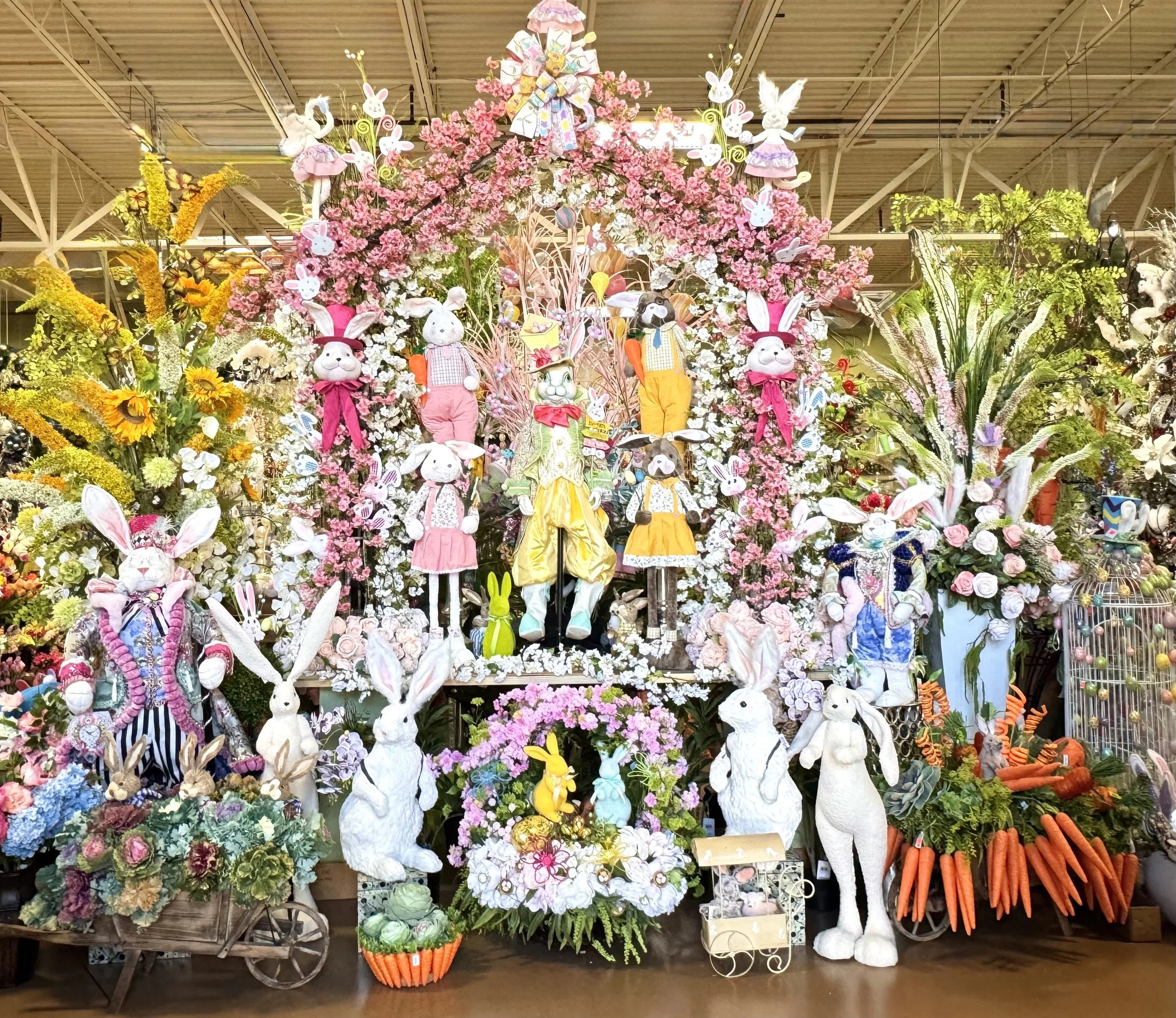 Easter and spring decorations in Houston featuring cherry blossom branches, bunny figures, floral wreaths, and pastel arrangements at the Arcadia showroom