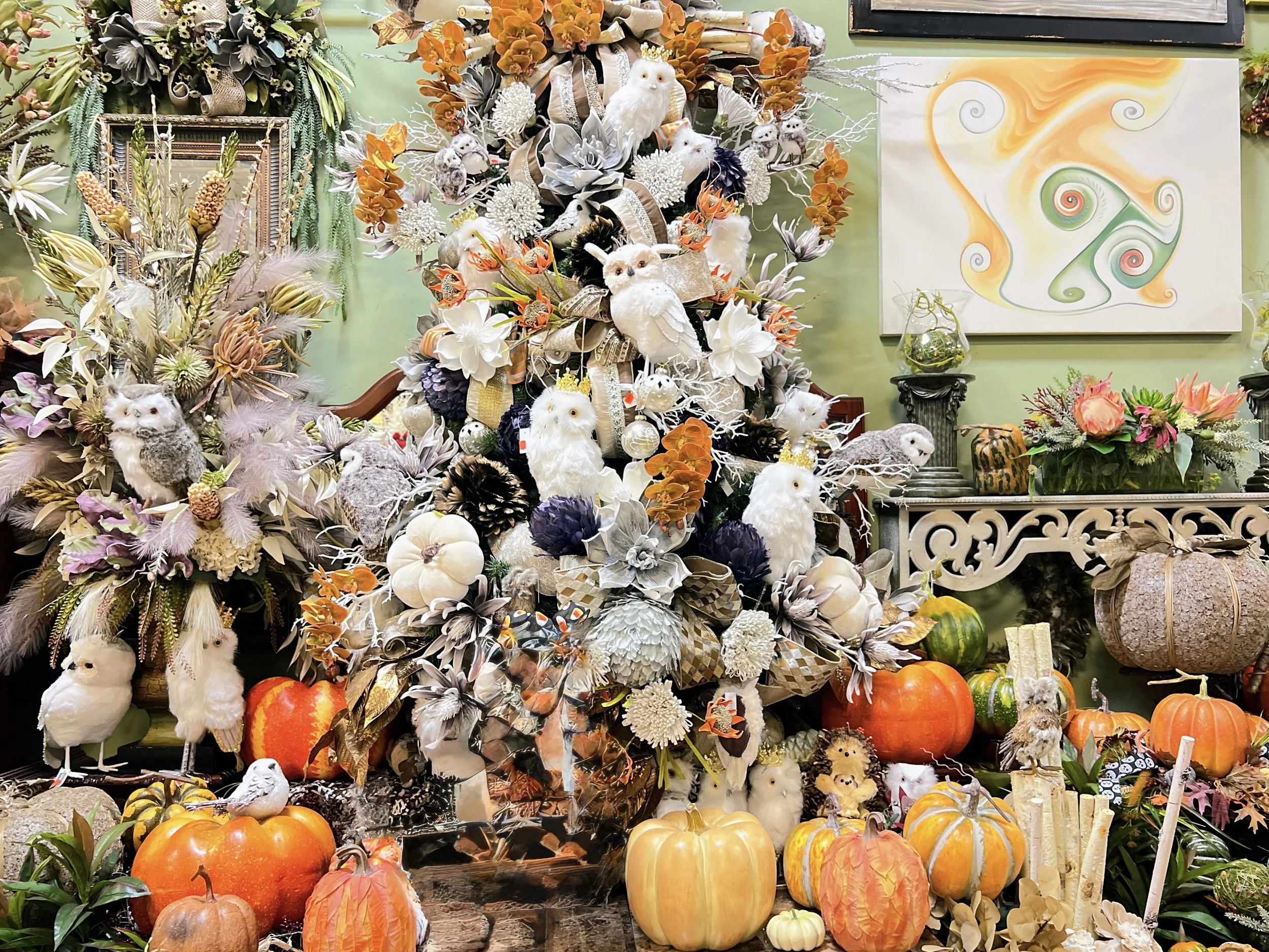 Fall decorations in Houston featuring a decorated harvest tree with owls, pumpkins, and floral accents in cream, plum, and burnt orange at the Arcadia showroom