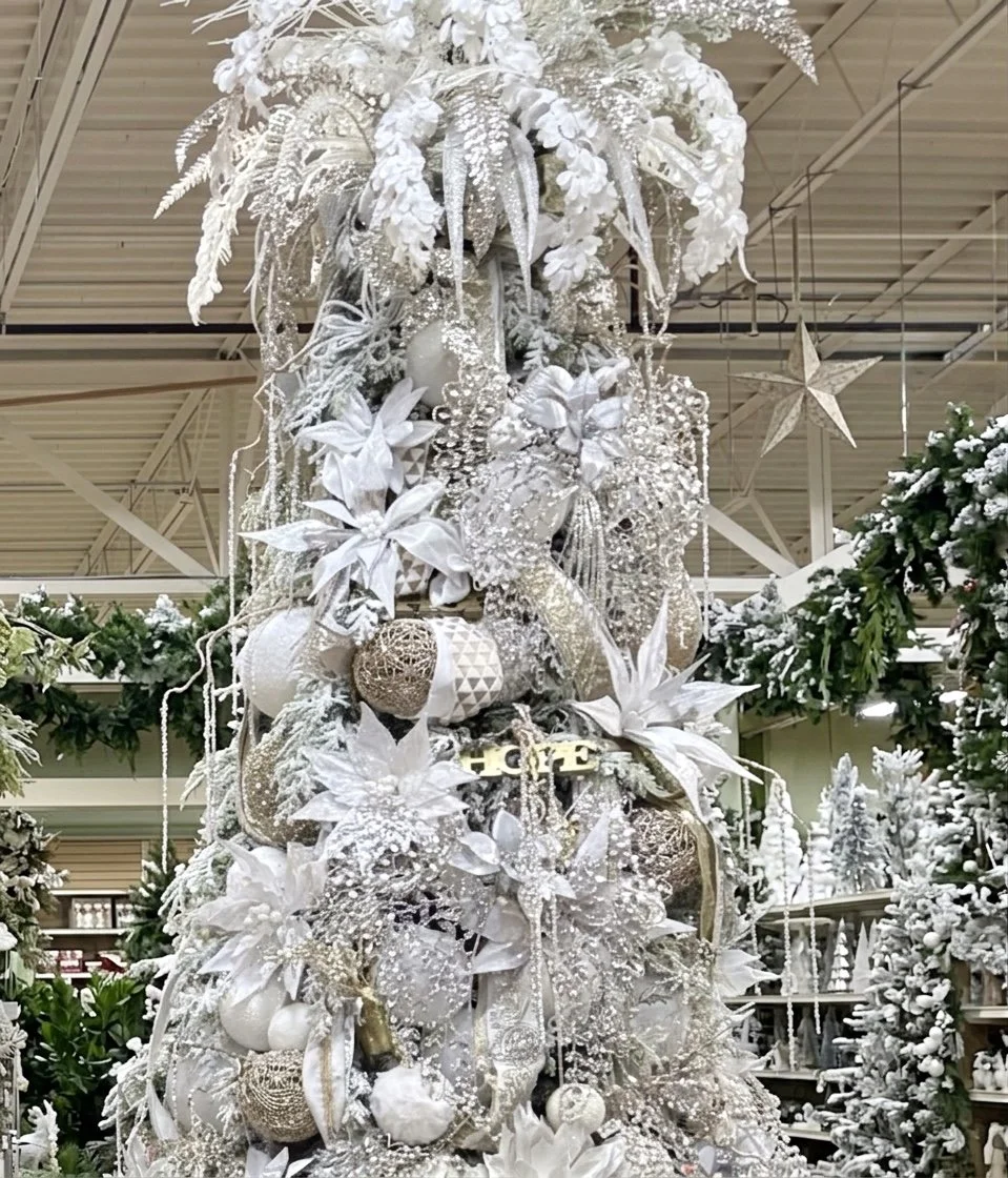 Pearl and winter white glam Christmas tree with silver poinsettia and beaded ornaments in Arcadia’s Houston showroom