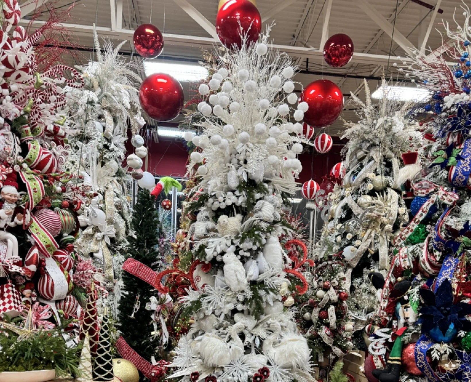 White Christmas tree decorated with snowball picks and feathered white sprays