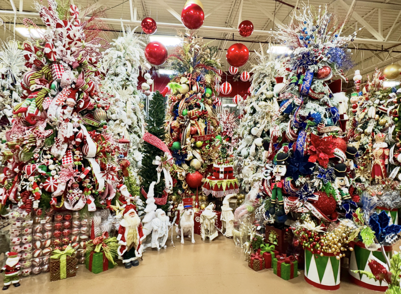 Christmas decorations in Houston featuring multiple decorated designer trees, ornaments, and holiday figures at the Arcadia showroom