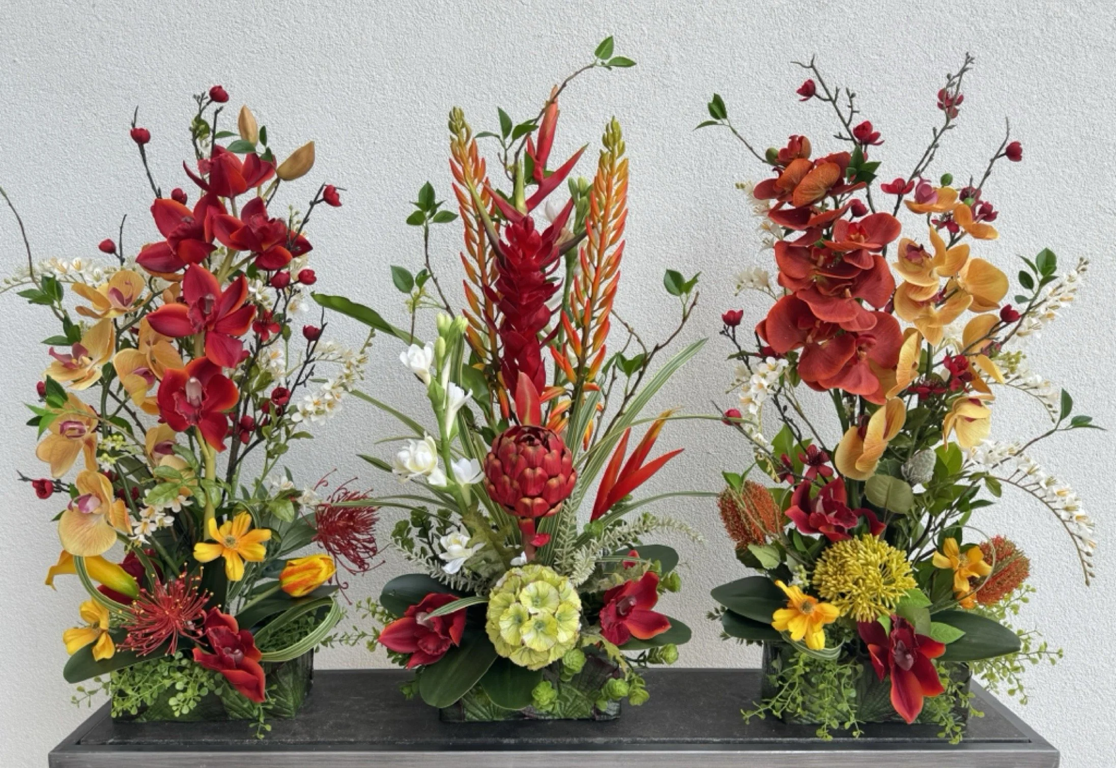 Custom silk flower arrangement in red ginger, protea, and orchids by Arcadia Floral & Home Decor in Houston