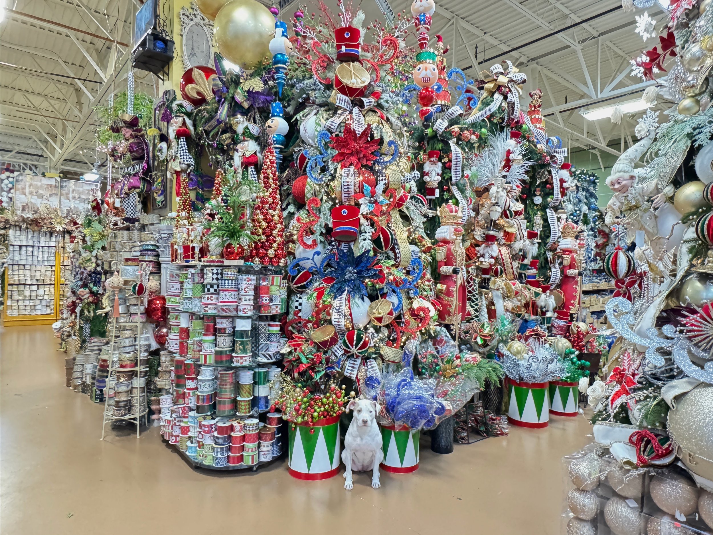 Nutcracker theme Christmas tree with toy drums and soldier ornaments beside the ribbon display