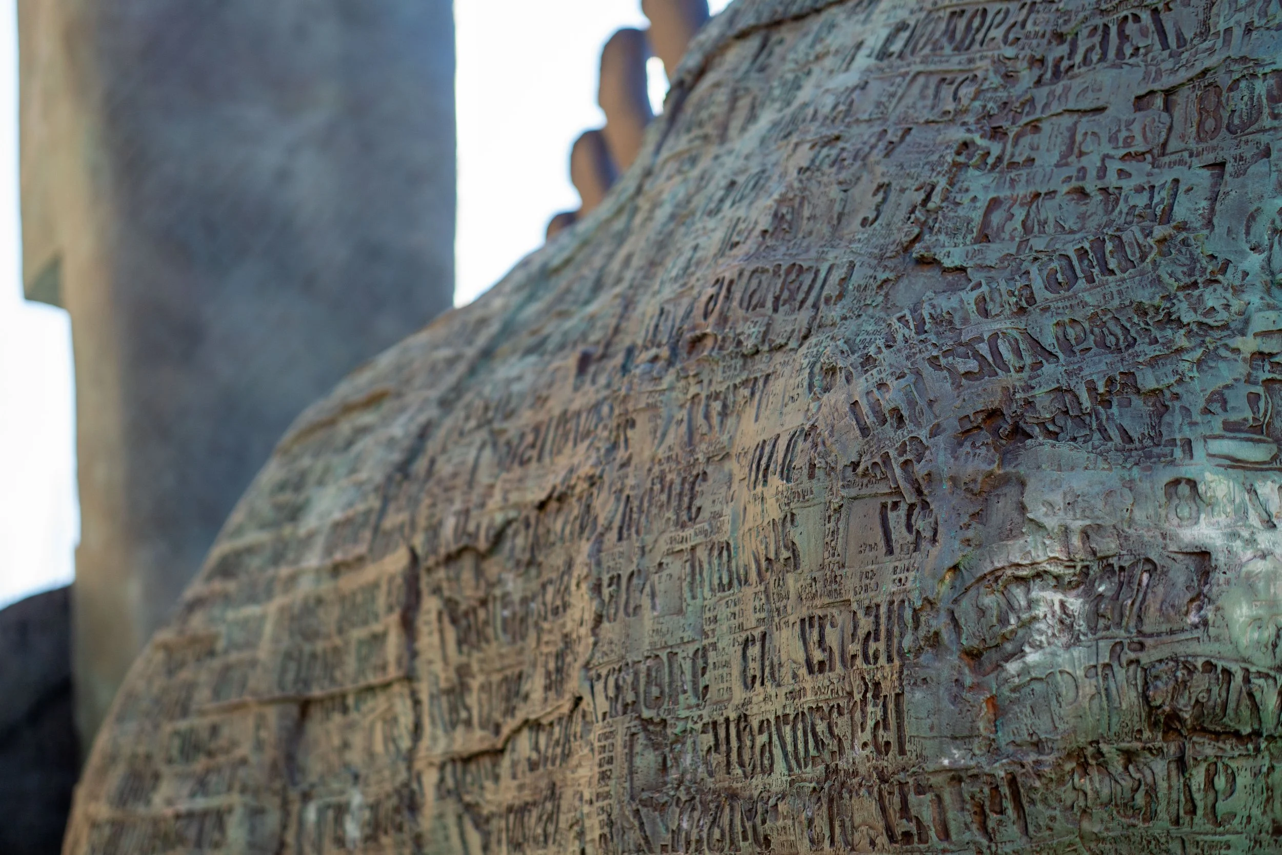 Arezzo – Bronze etched with countless words, a surface where memory clings and history breathes silently.