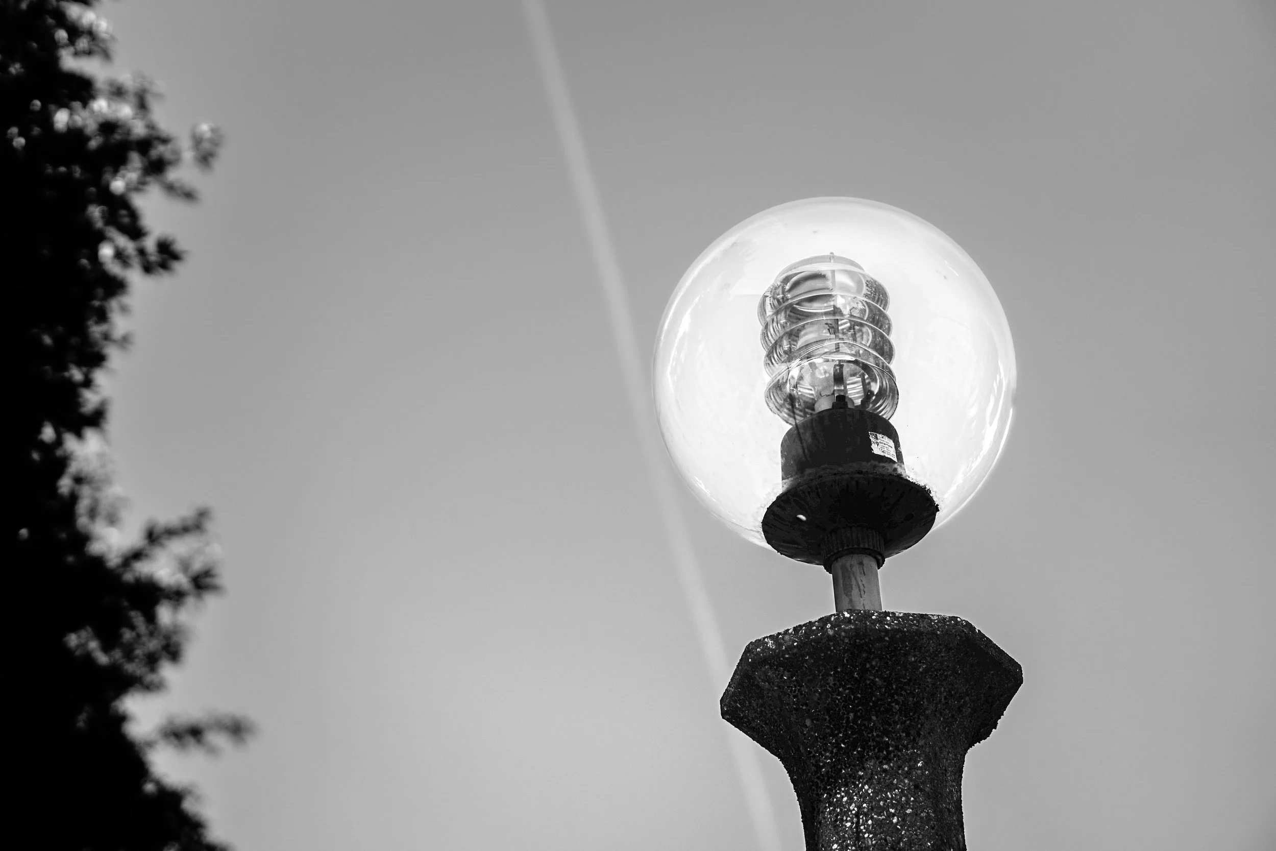 Arezzo – A glass sphere traps the sky, light and shadow merging in fragile modern geometry.